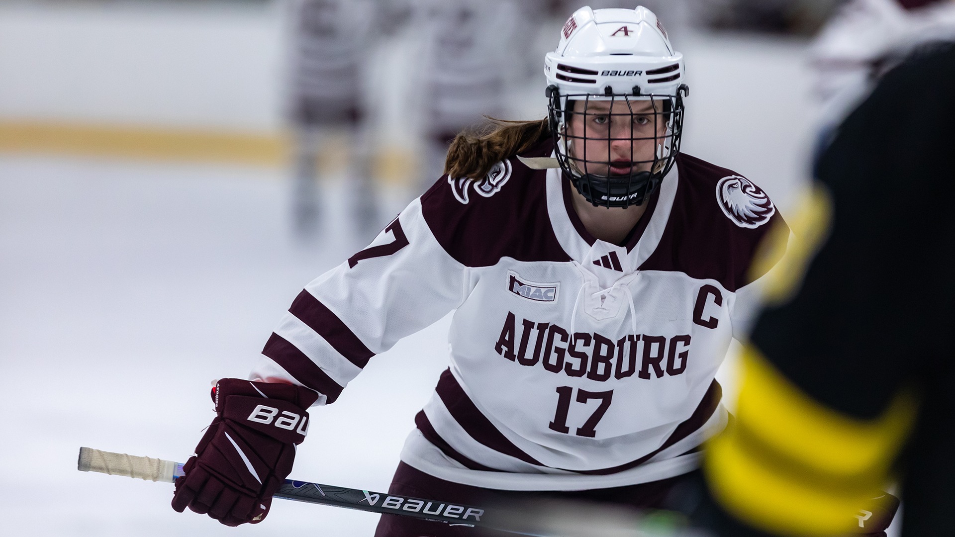 Emily Schoeberl faces off during a 2025-26 Augsburg women's hockey game.