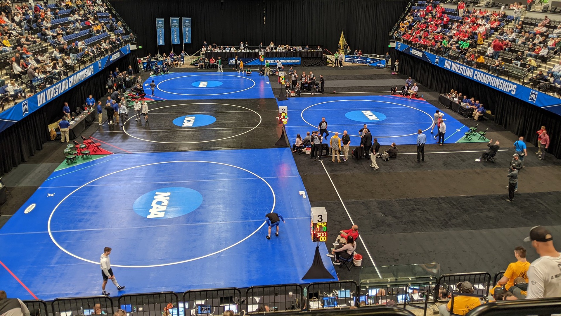 Shot of the mats on the floor of the Cedar Rapids arena for the 2022 NCAA Division III Men's Wrestling National Championships.