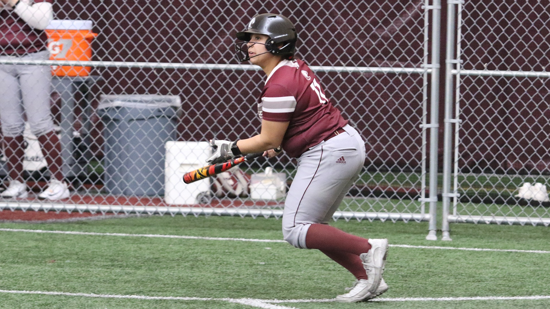 Jayden Evenson watches a hit from the plate during a 2026 Augsburg softball game.