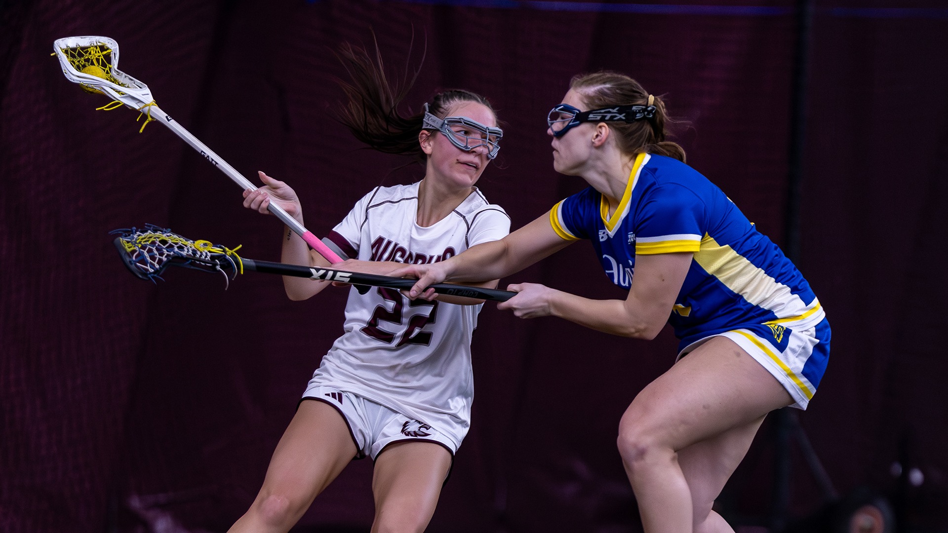 Leila Klym handles the ball against an opponent during a 2026 Augsburg women's lacrosse game.