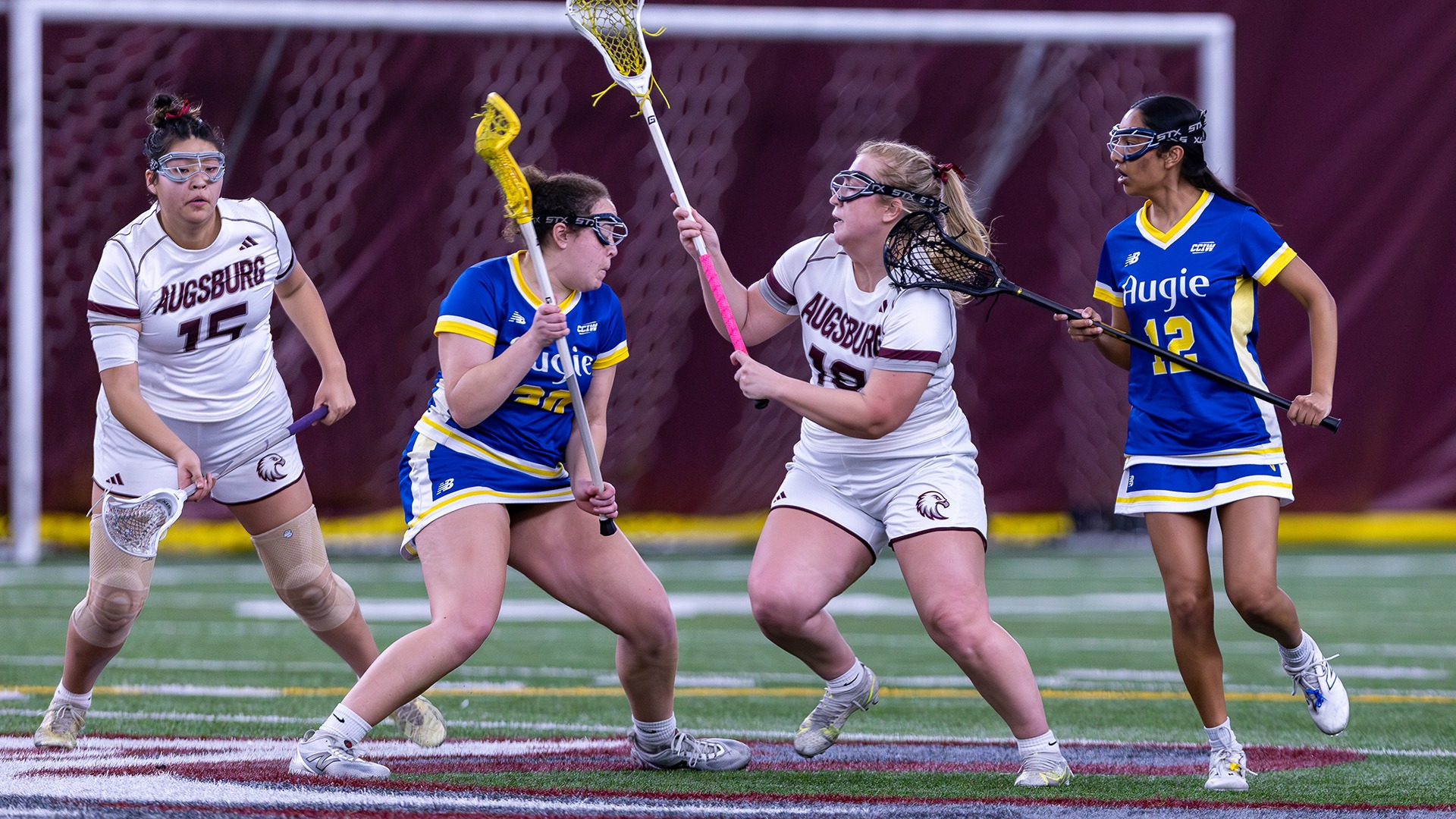 Breya Sawyer defends against an attacker during a 2026 Augsburg women's lacrosse game.