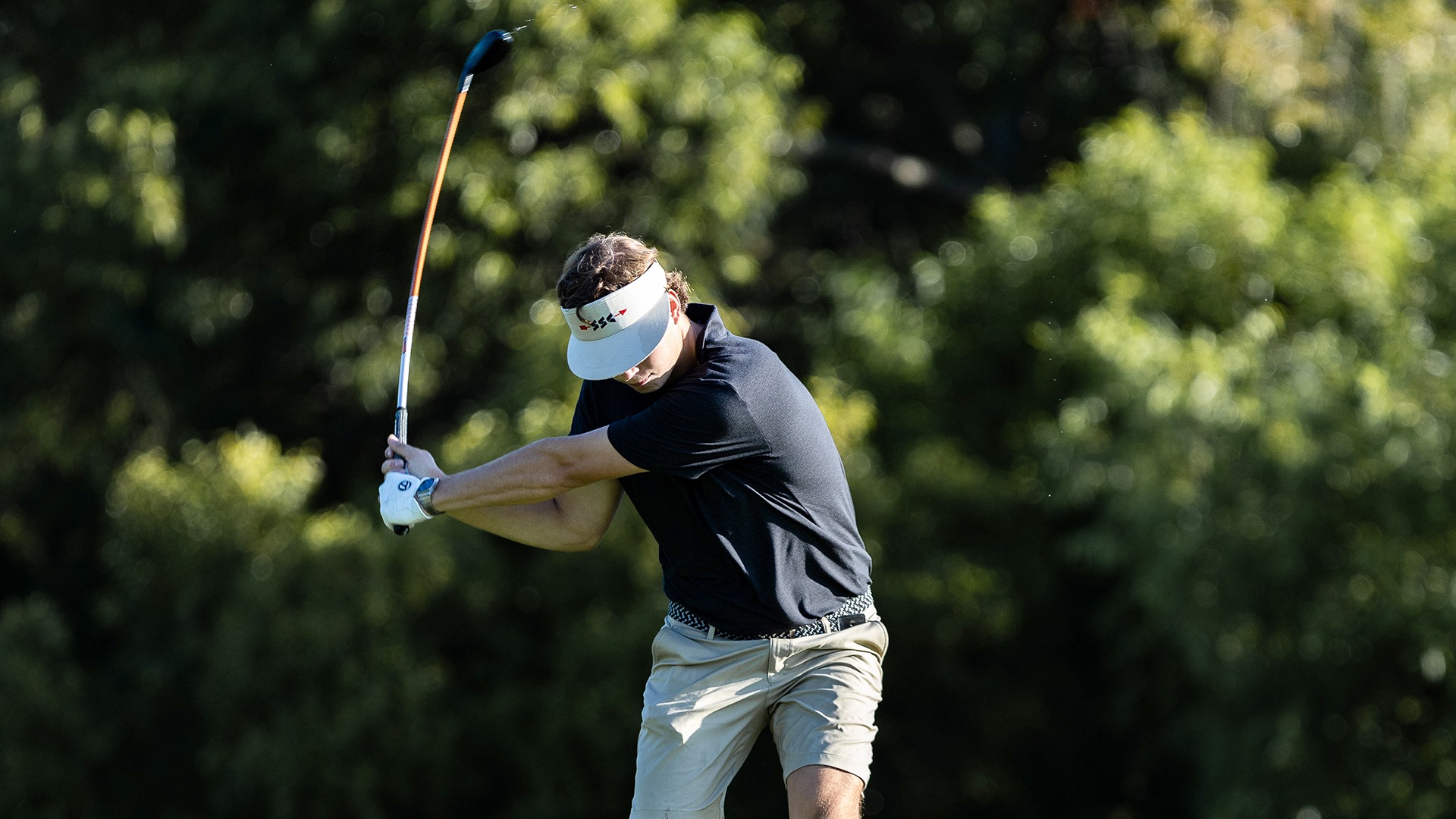 Jack Berry swings for a golf shot during a 2025-26 Augsburg men's golf meet.