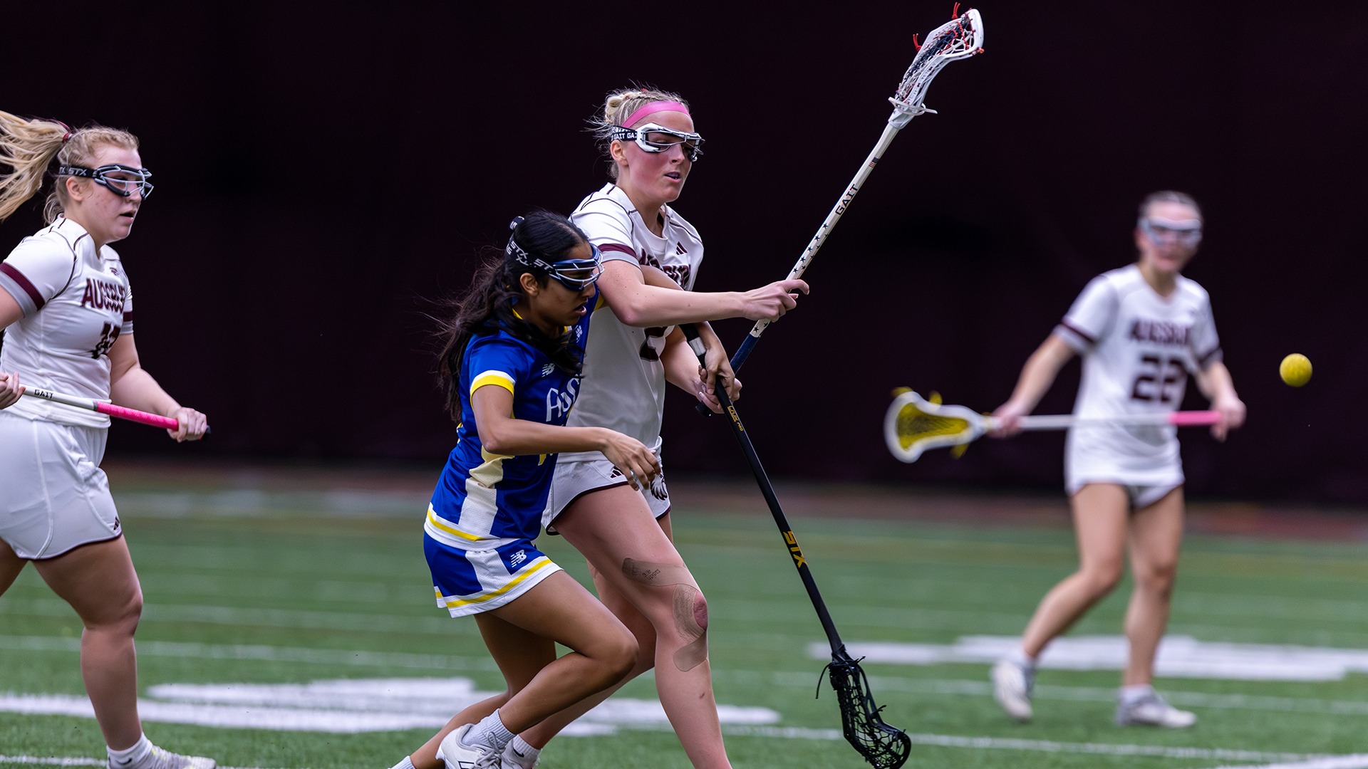 Emma Ryan battles an opponent for the ball during a 2026 Augsburg women's lacrosse game.