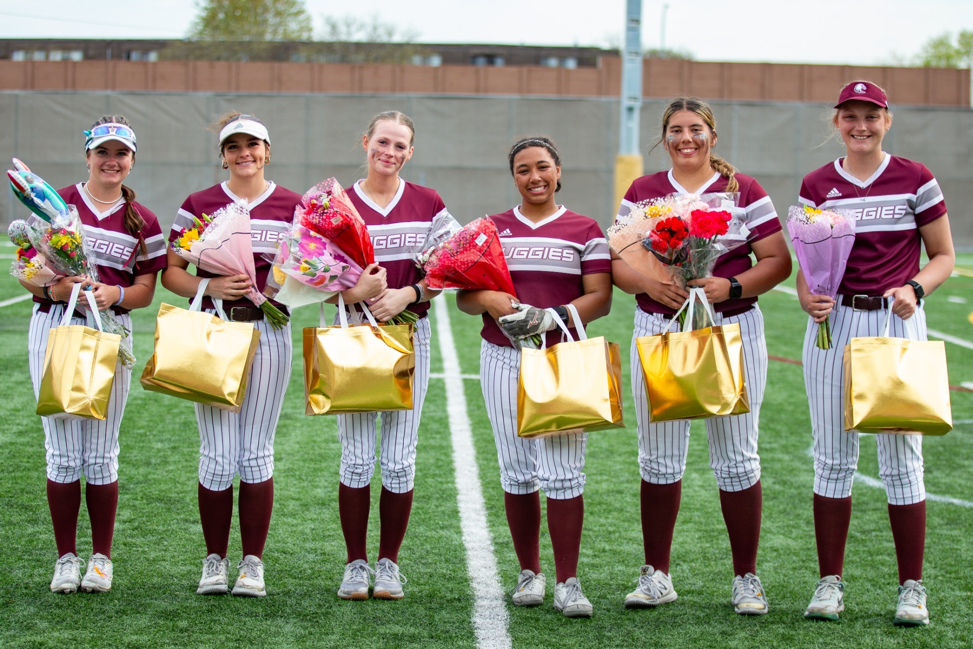 Augsburg softball seniors pose for a photo during a 2026 game.