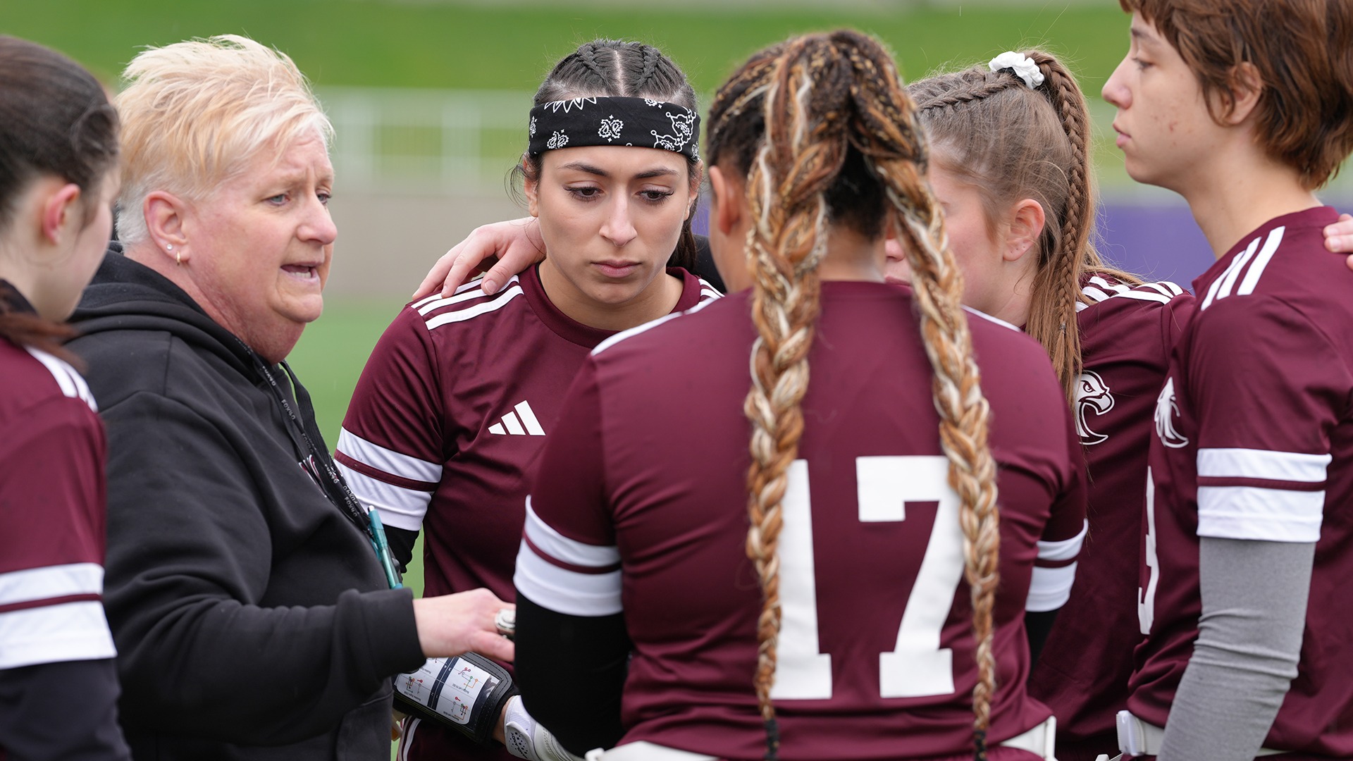 Coach Michele Braun gives instructions to her flag football players during a 2026 game.