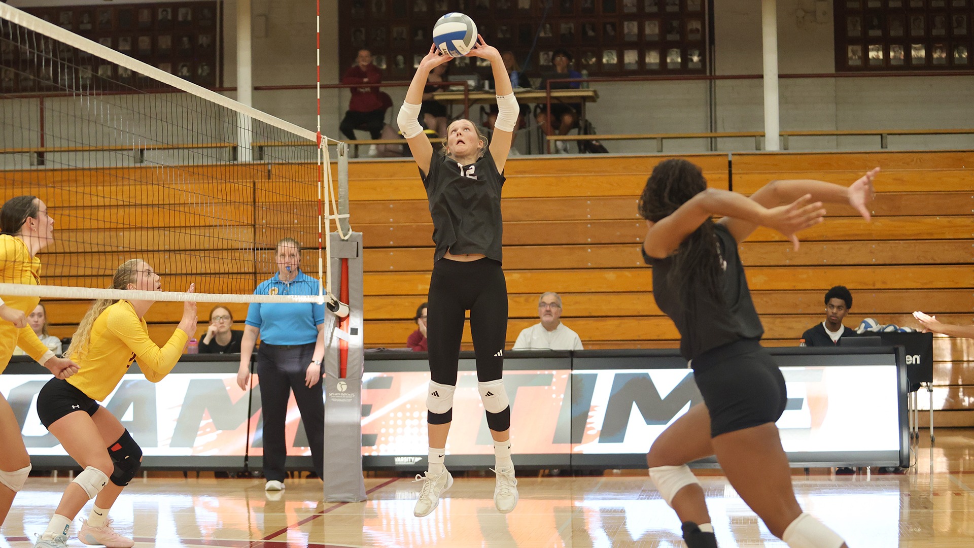 Jovial King sets the ball during a 2026 Augsburg volleyball match.