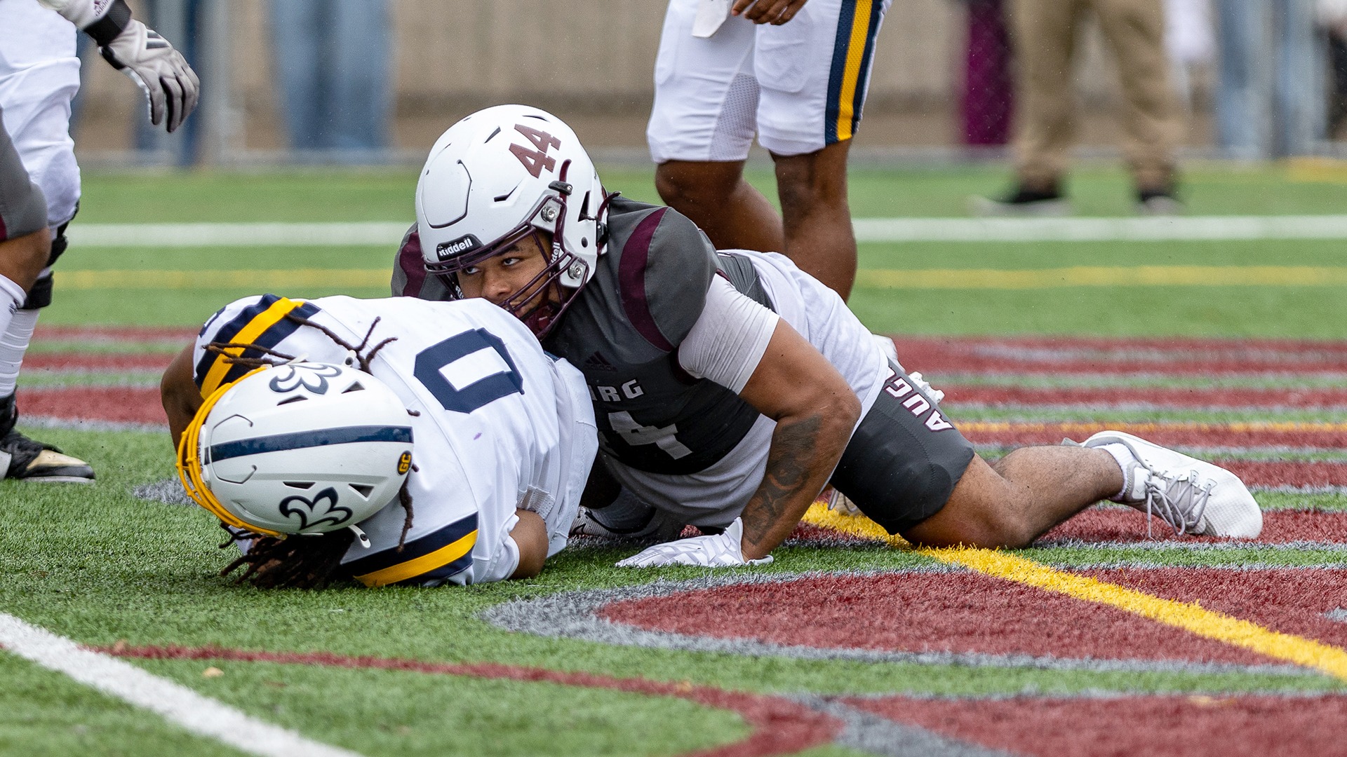 RJ Chakolis tackles an opponent in the end zone for a safety during a 2026 Augsburg football game.