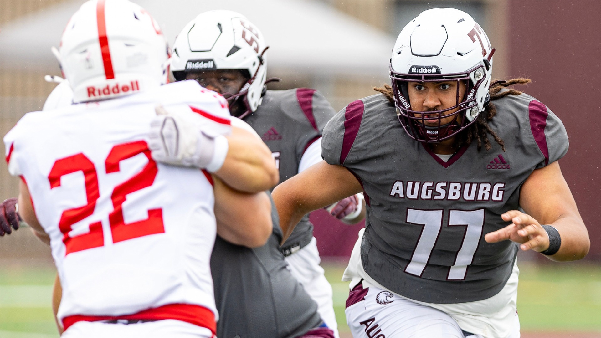 Corey DeLoach and Jaedon Nygaard block in front during a 2026 Augsburg football game.