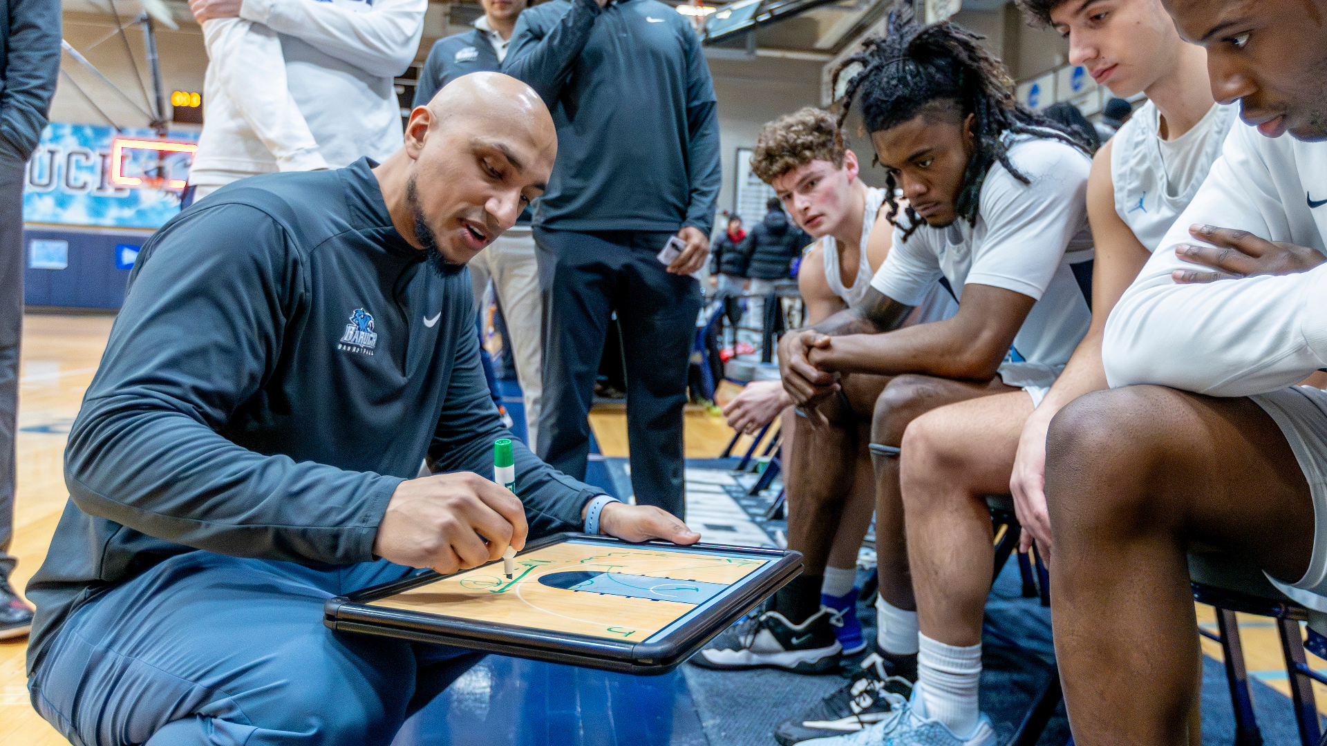 Head Coach Tammer Farid talling to team during a timeout. 