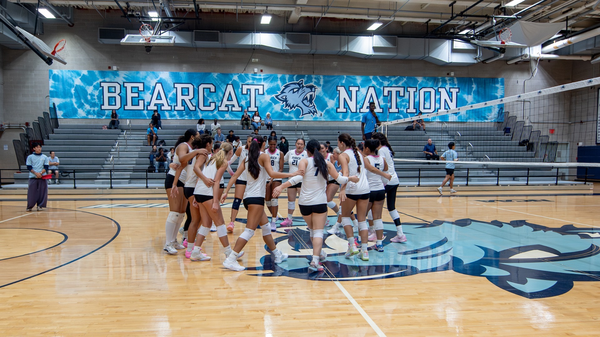 2026 Baruch women's volleyball in the huddle. 