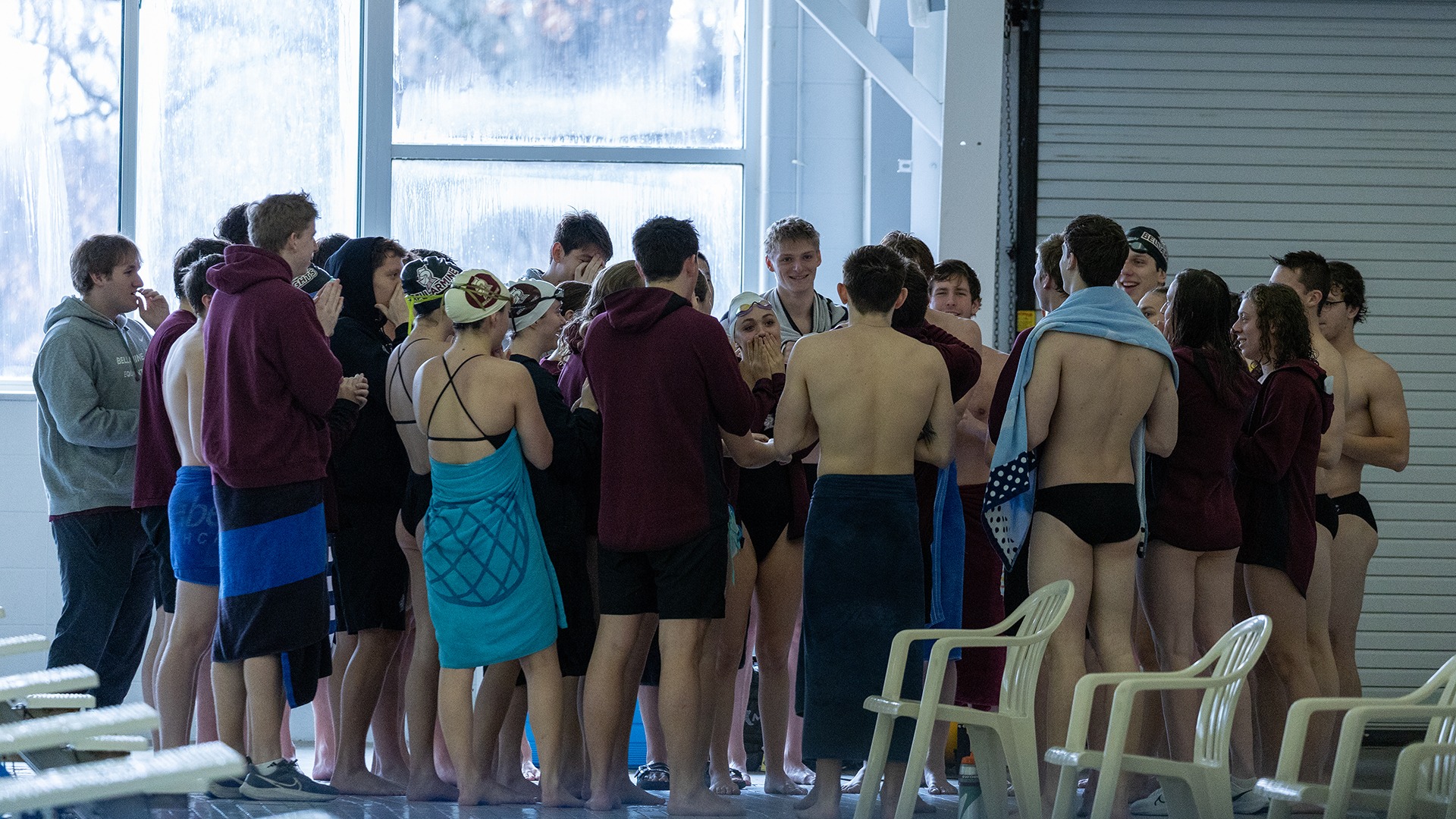 Knights swimming huddles in a dual against Evansville.