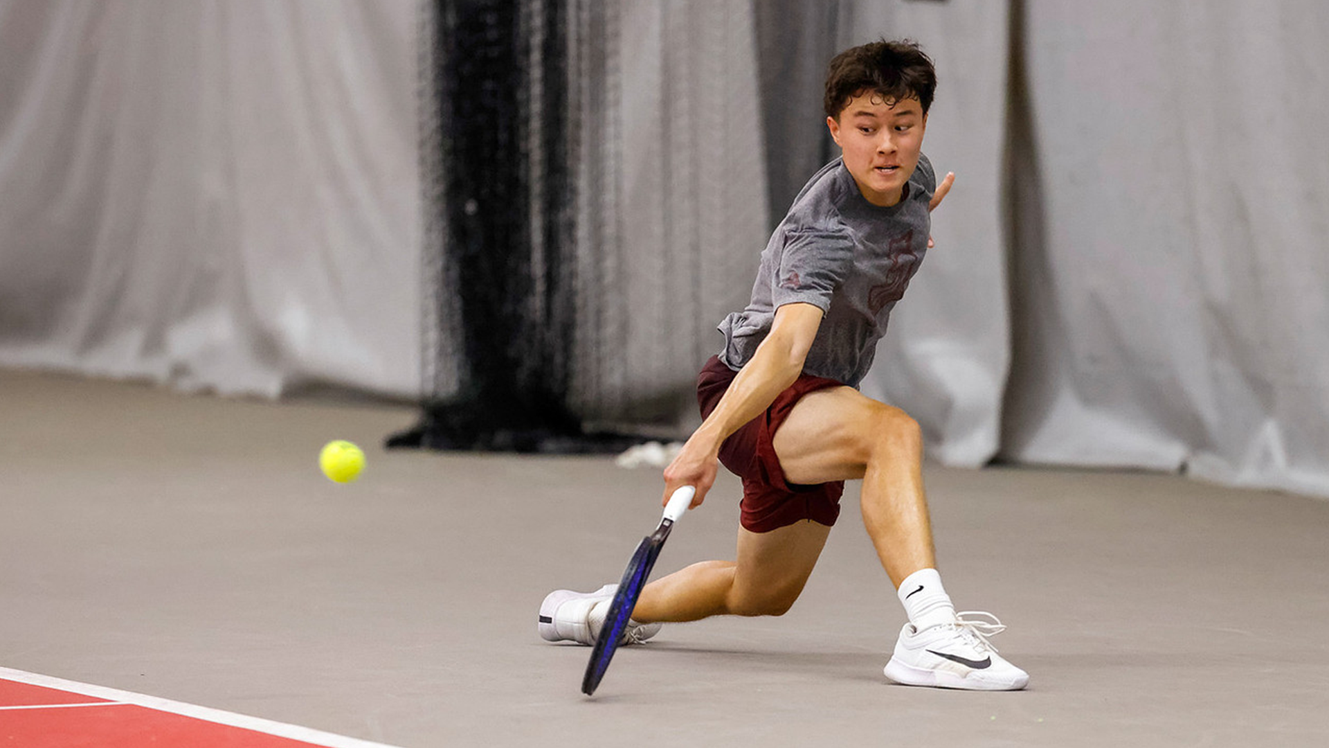 Sebastian Baumann slides to return a ball