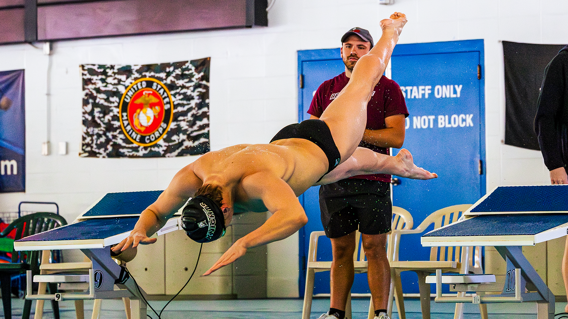 Men's swimmer dives in to the pool