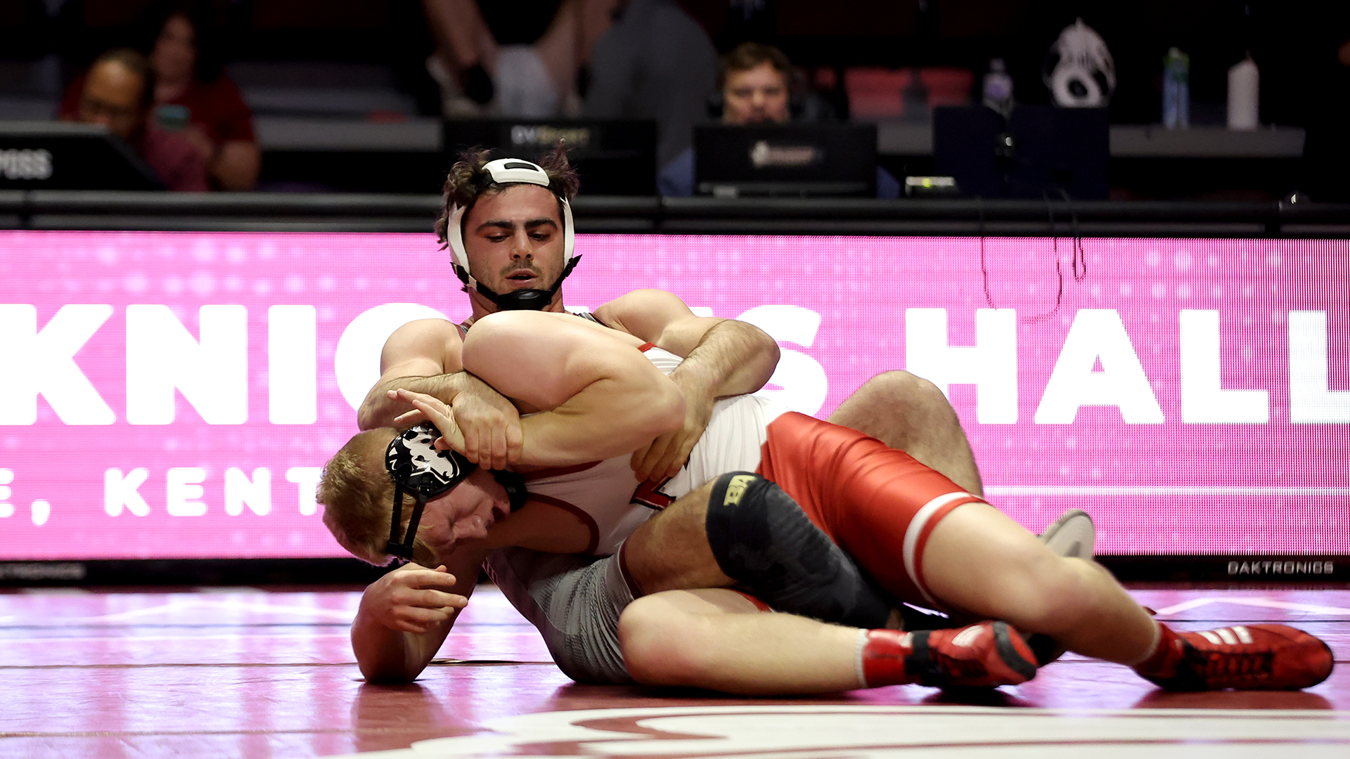 Andrew Liber works for a pin on his NIU opponent