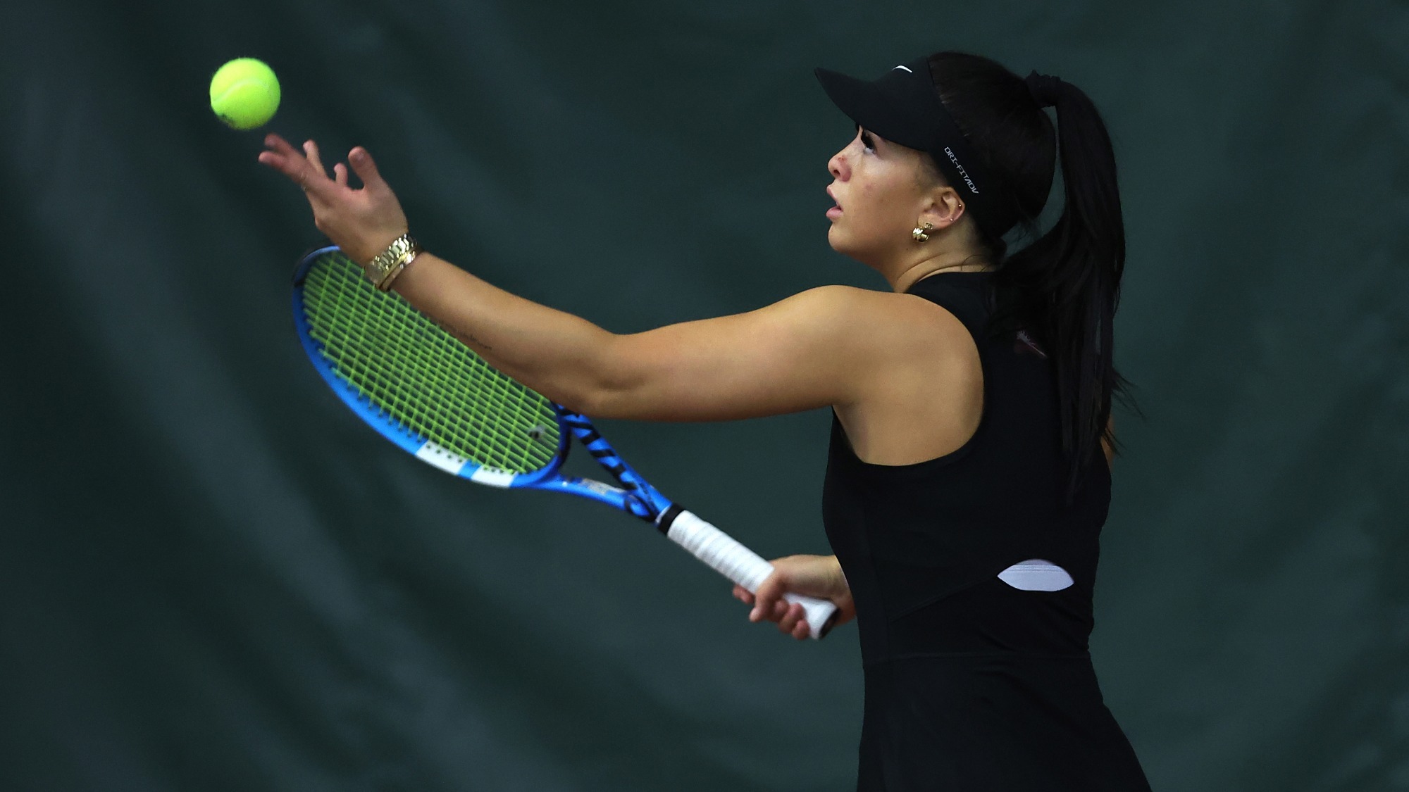 Gracie Hurley tosses the ball up for a serve against Cumberlands