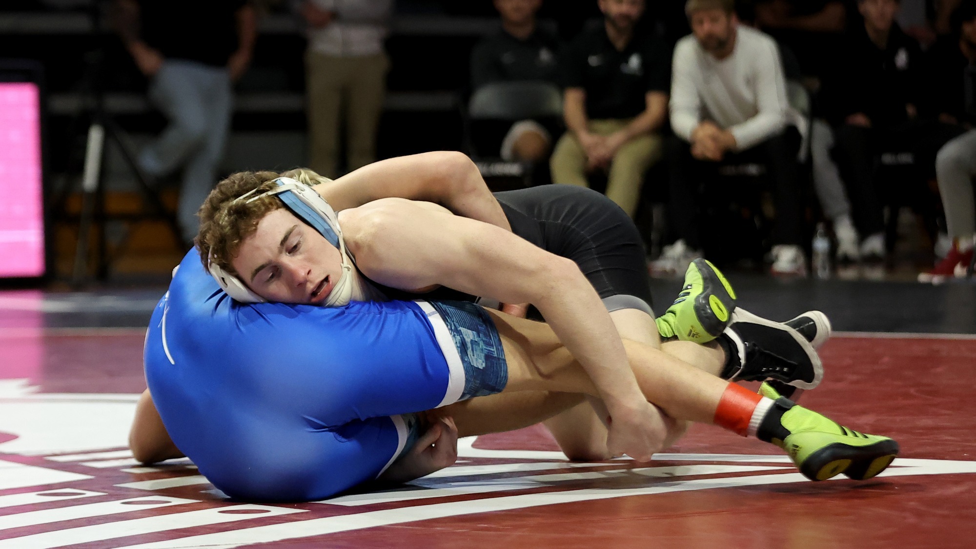 Noah Hall pushes his Presbyterian opponent into the mat