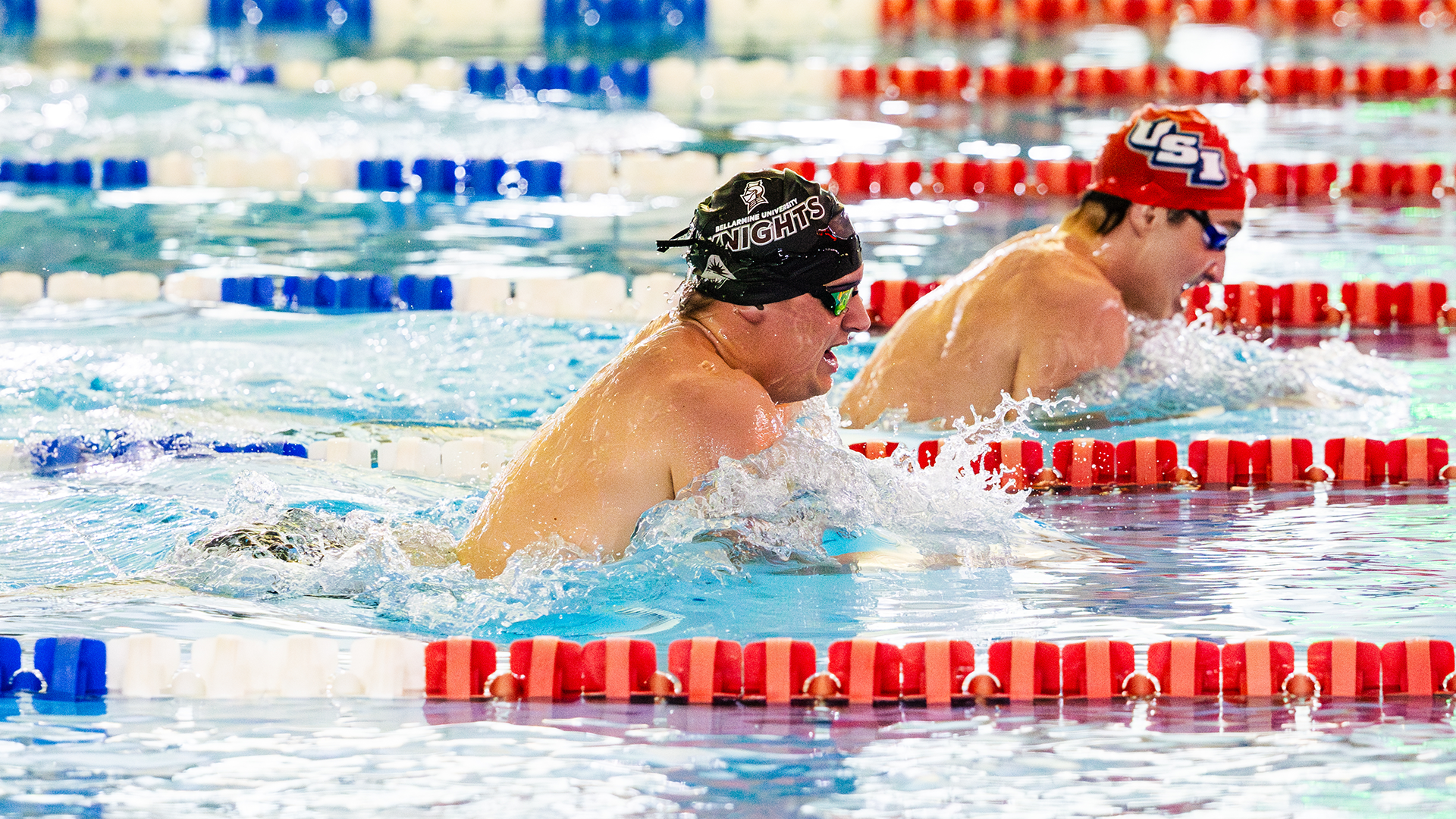 Men's swimmer racing against USI