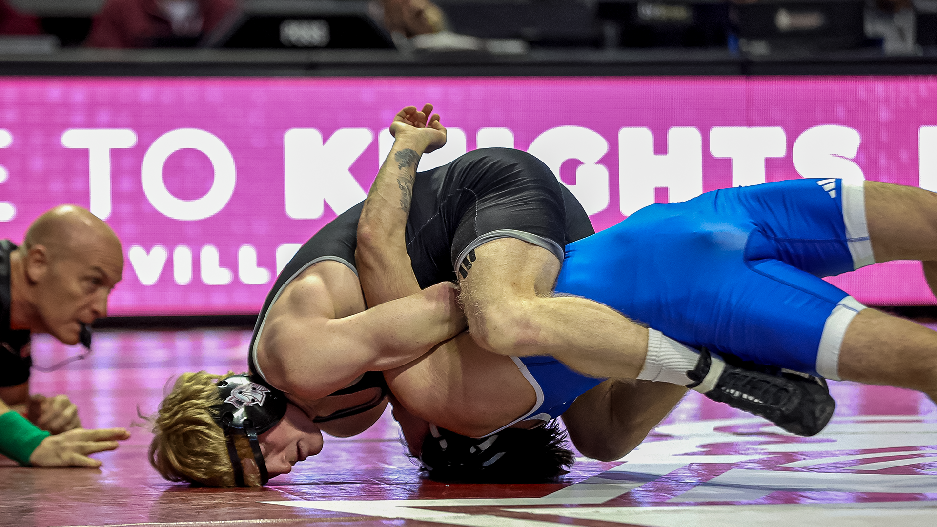 Trayce Eckman works to pin his Presbyterian opponent