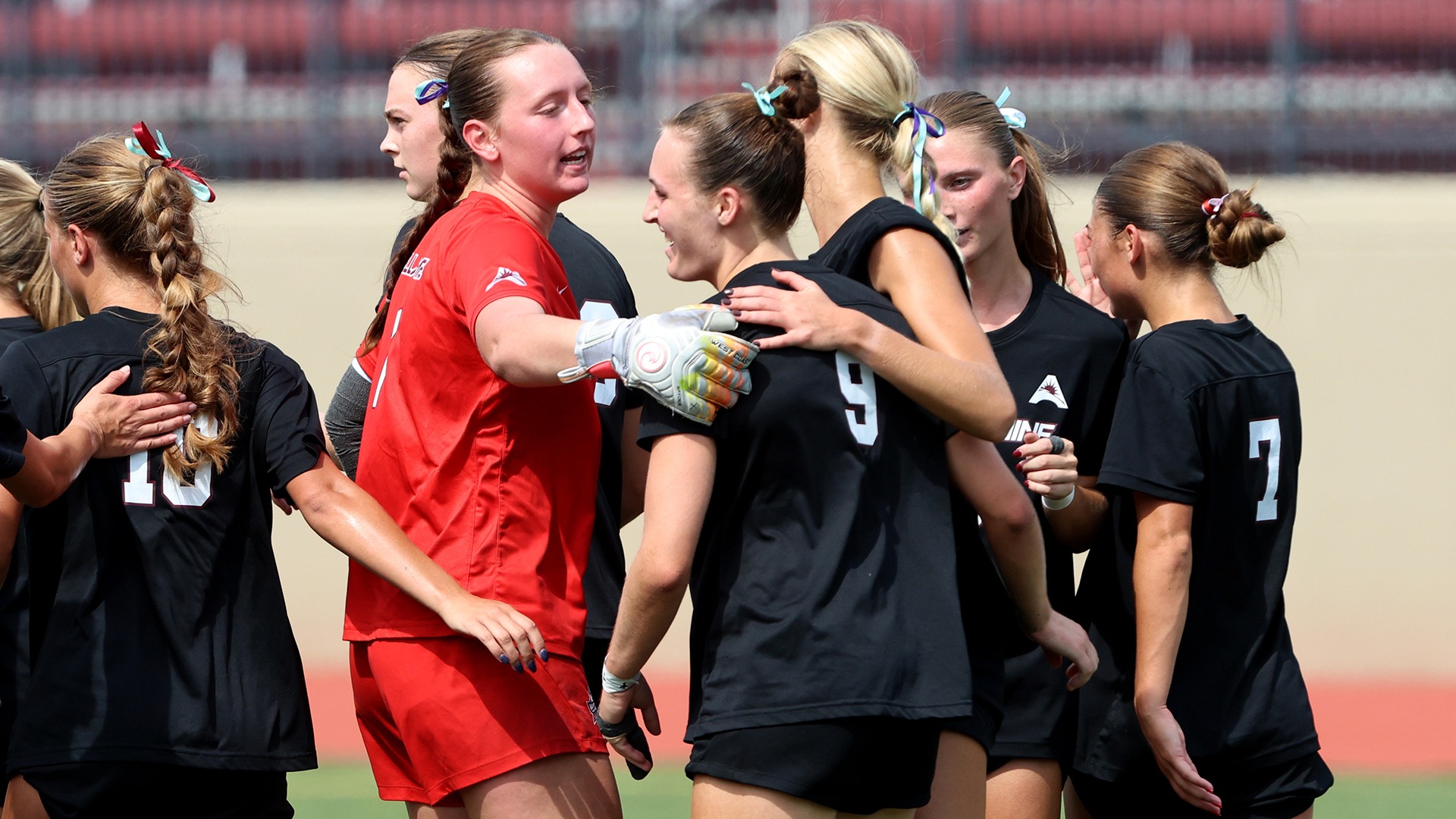 Women's soccer celebrates a goal this season.