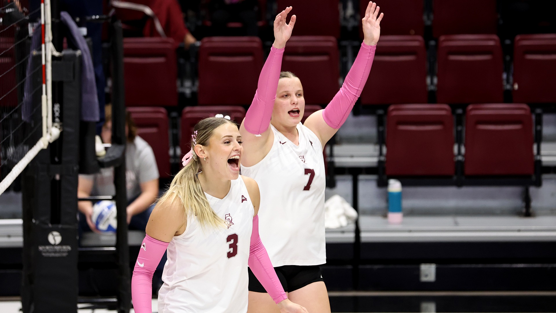 Maddie Carnes and Erika Smith celebrate a point won.