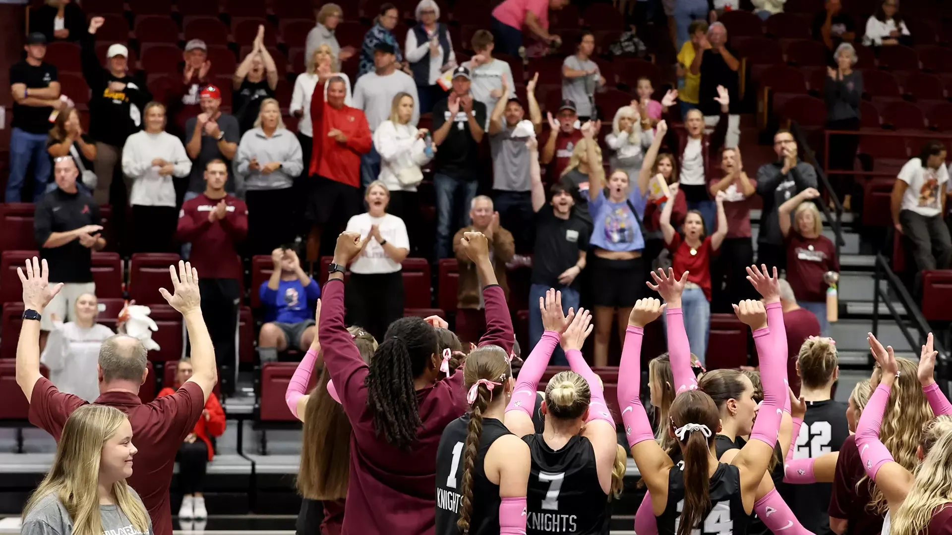 Bellarmine volleyball celebrates a win over North Florida with fans.