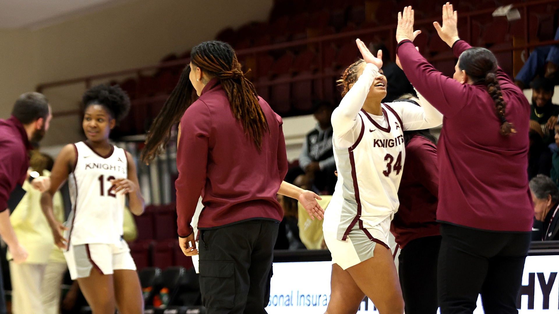 Patricia Sherrill is high-fived by assistant coach Alison McCarthy after a timeout.