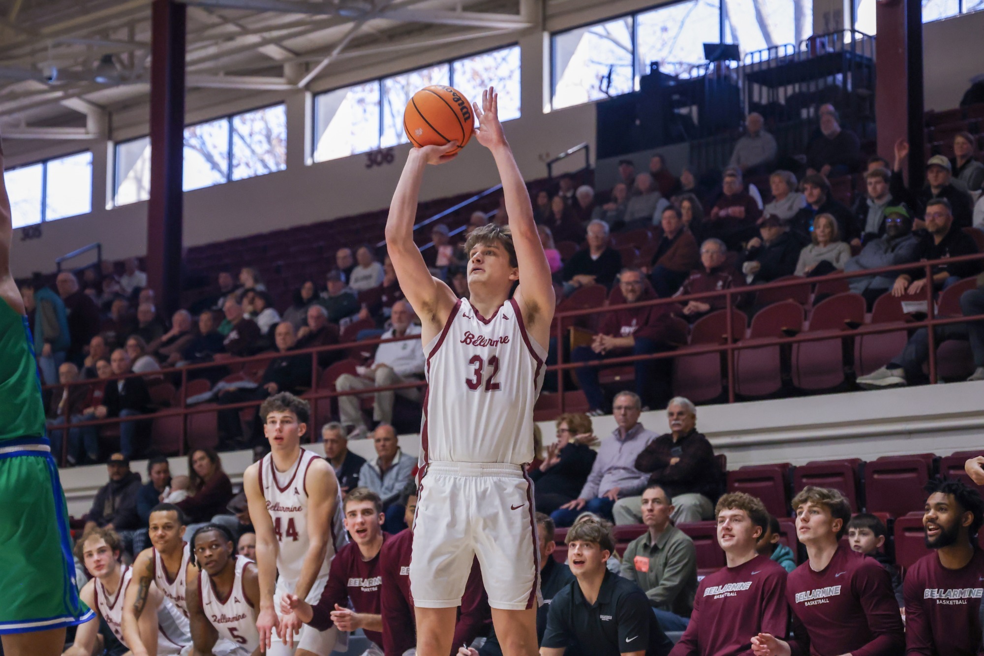 Jack Karasinski shoots a three in front of the Bellarmine bench