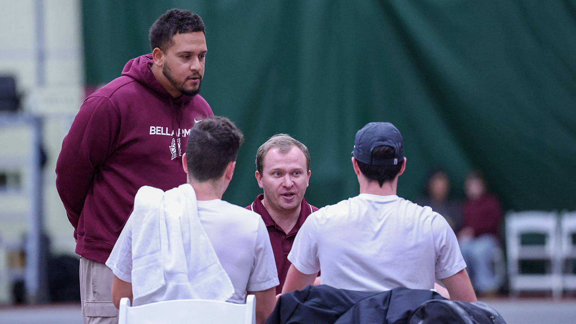 Head coach Will Davis and assistant coach Sebastian Bromley talk with Matthew Nice and Colby Berson