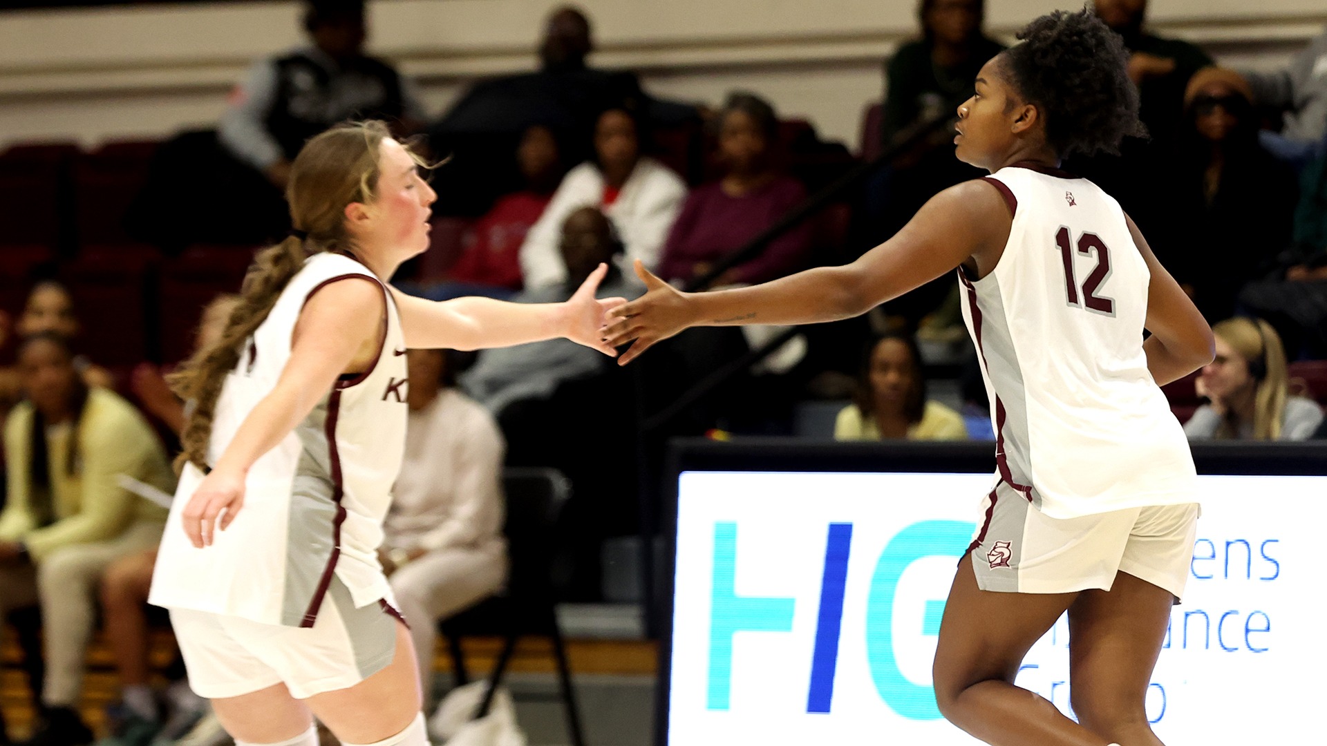 Oliver Pifer and Kayce Hyman clap hands after a basket.