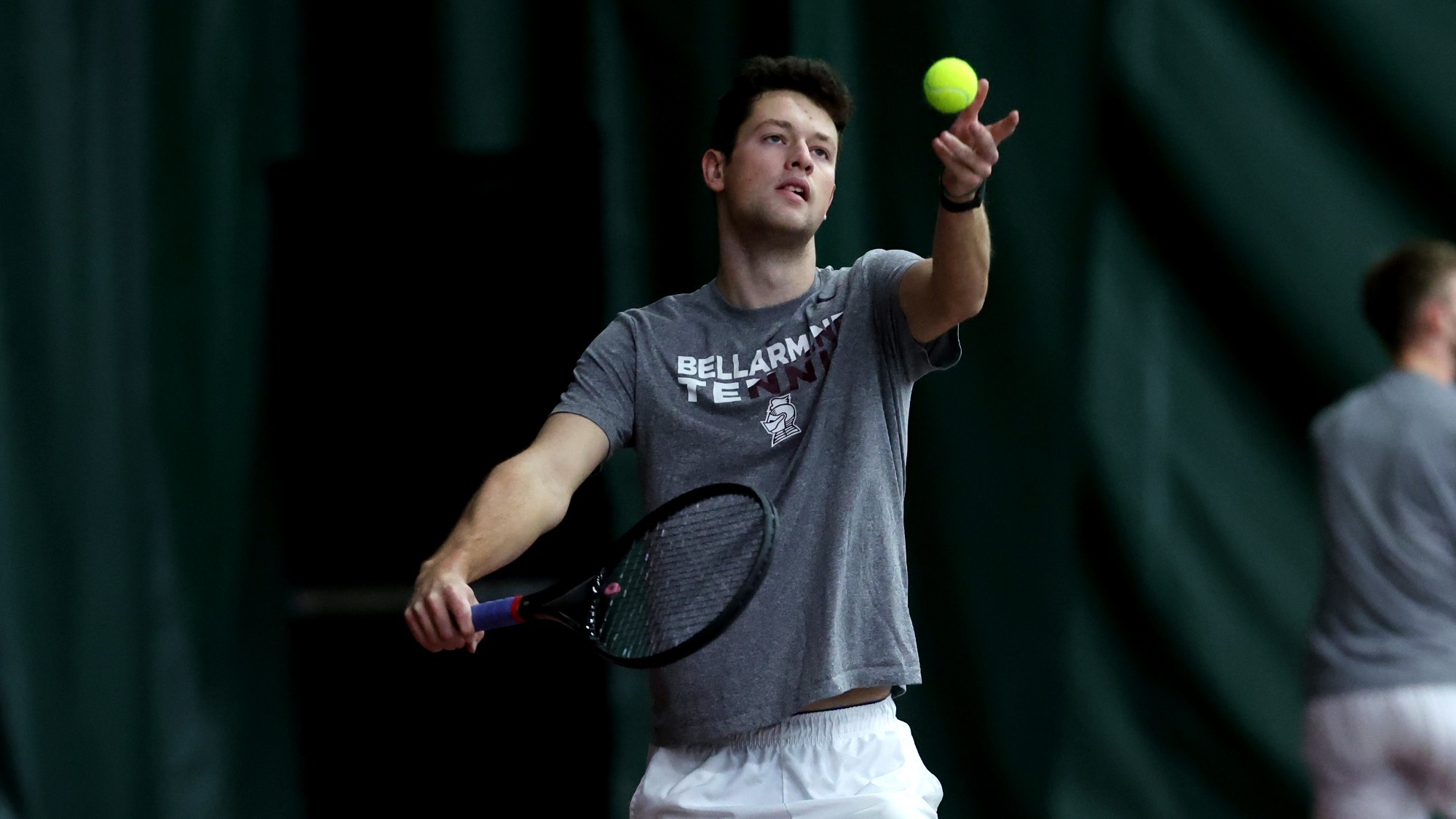 Matthew Nice tosses the ball up to serve to his JMU opponent