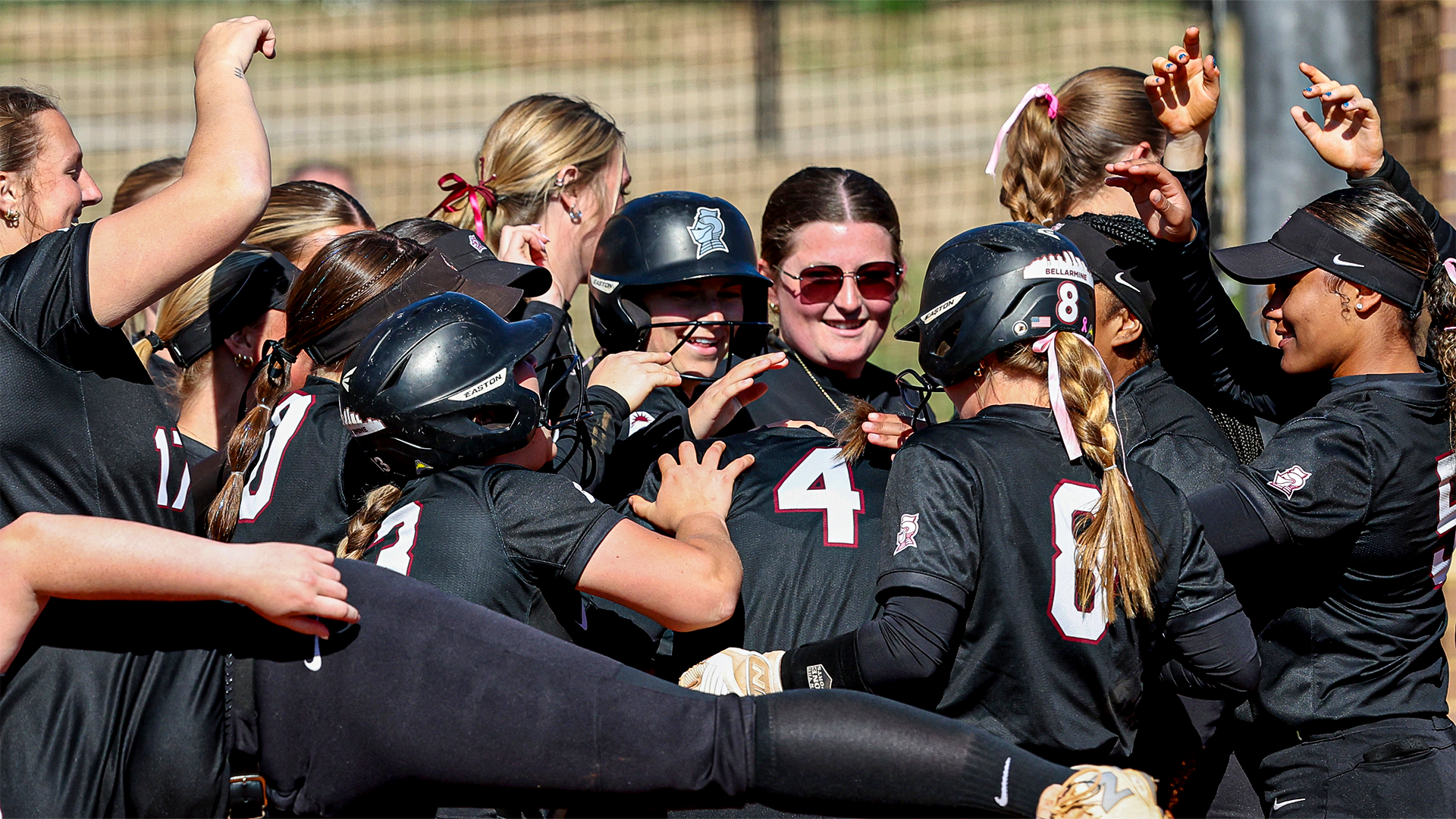 Softball team huddles around Lily Jones after her first career home run against IU Indy