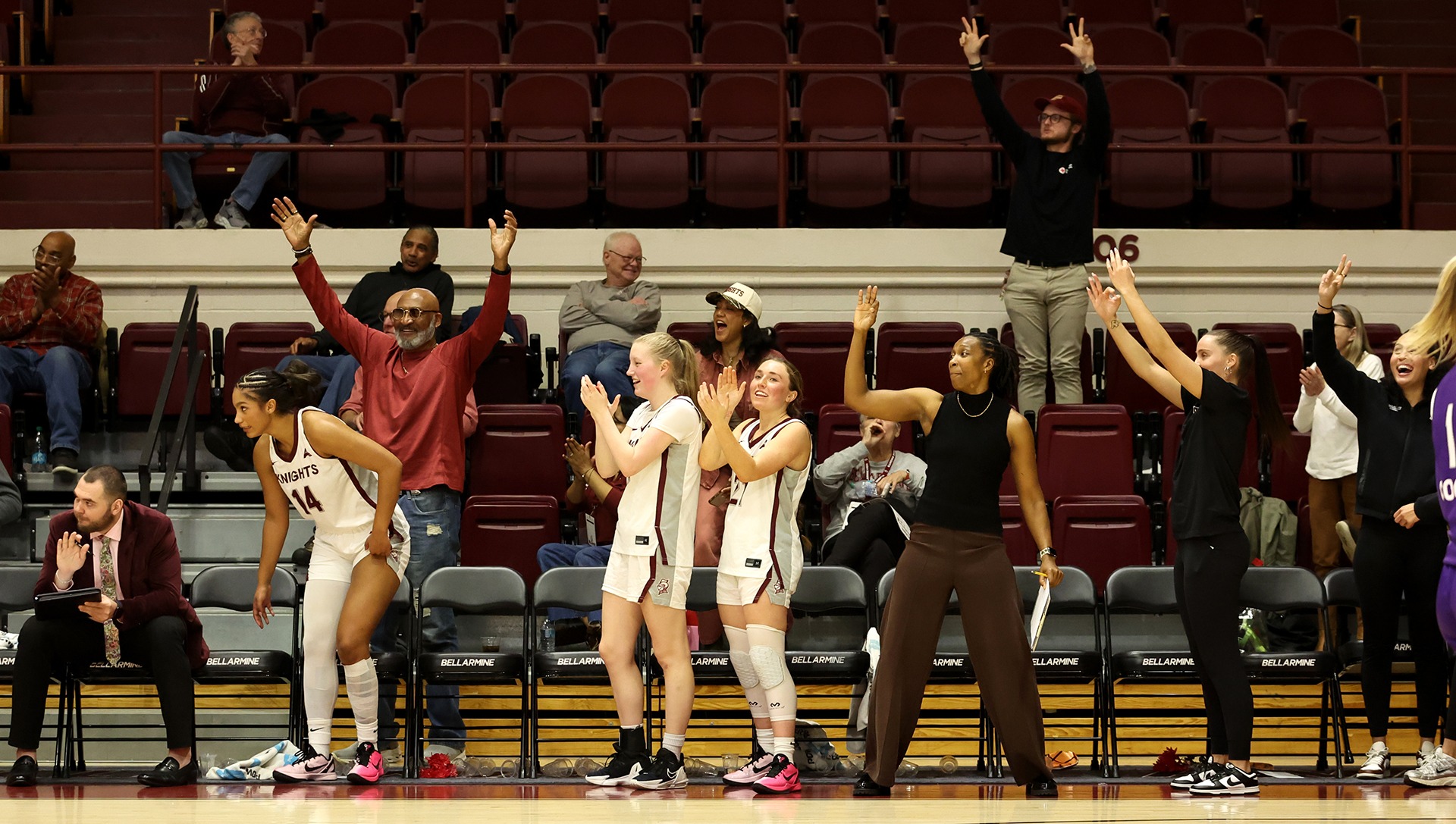 Women's basketball celebrates a basket against UNA.