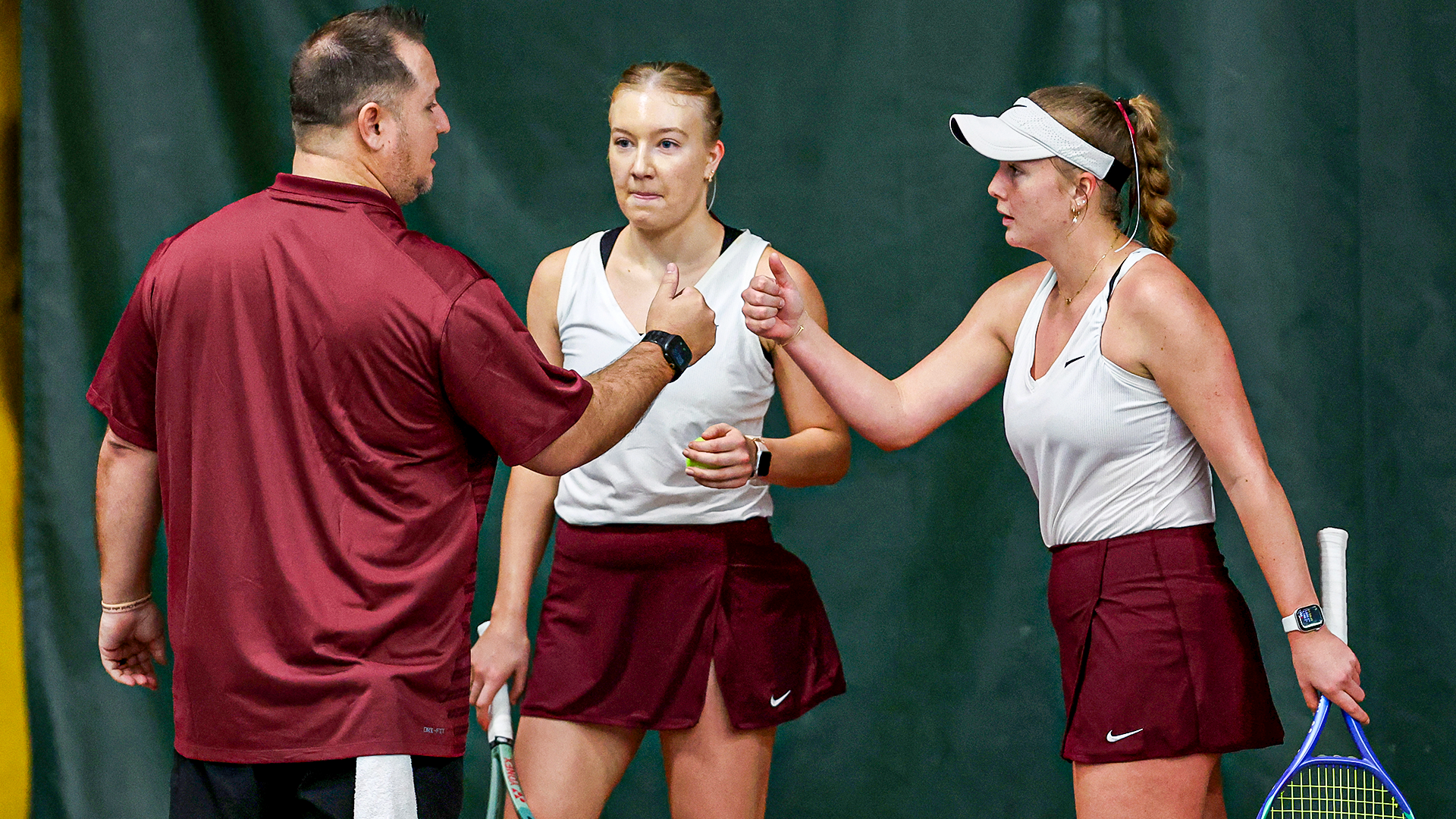 Head Coach Brian Slack congratulates Vendula Kryslova and Reese Parker after a win
