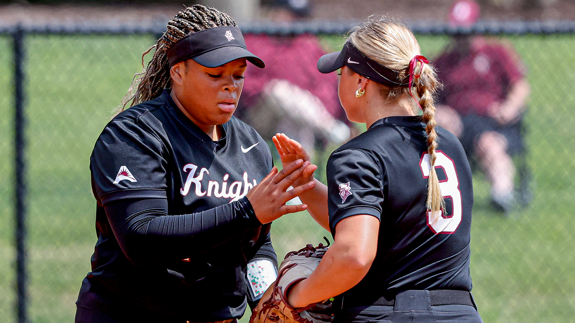 Lele Bennett and Tatum Harper high-five in the circle 