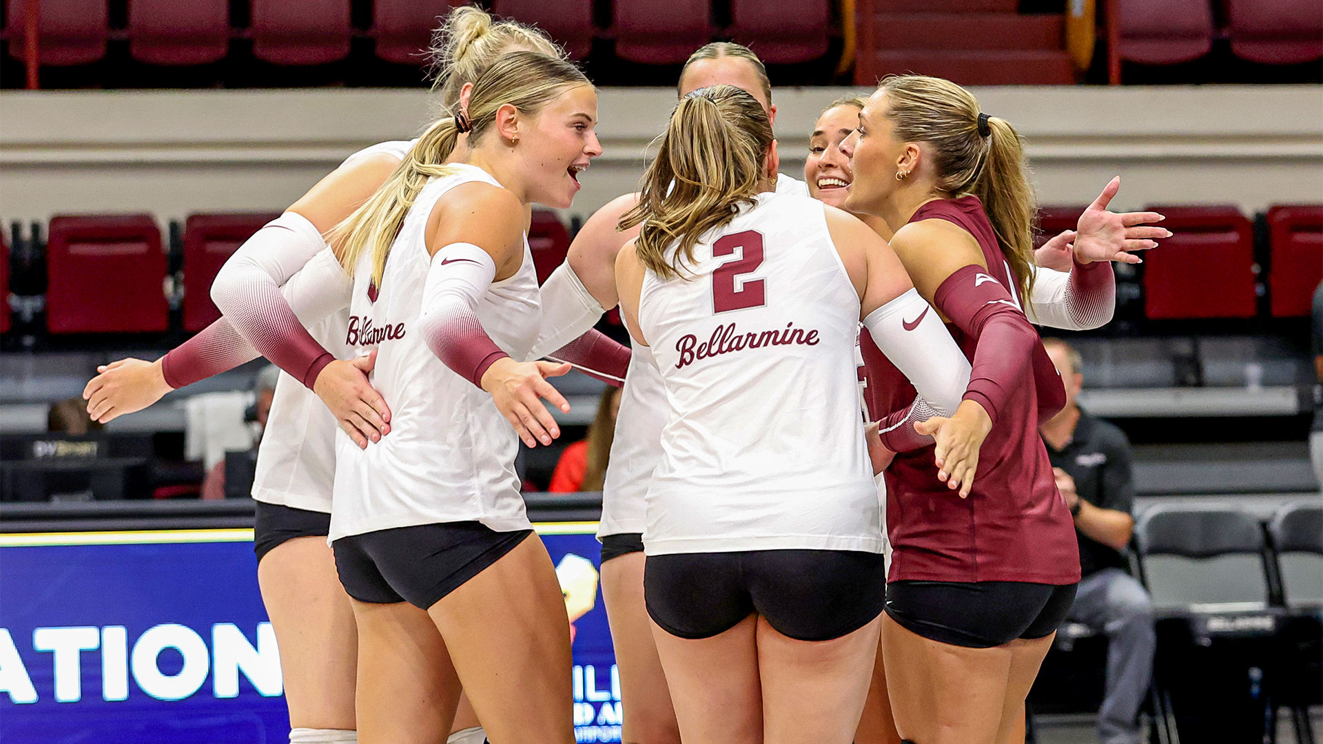Volleyball team huddled during match against Rutgers