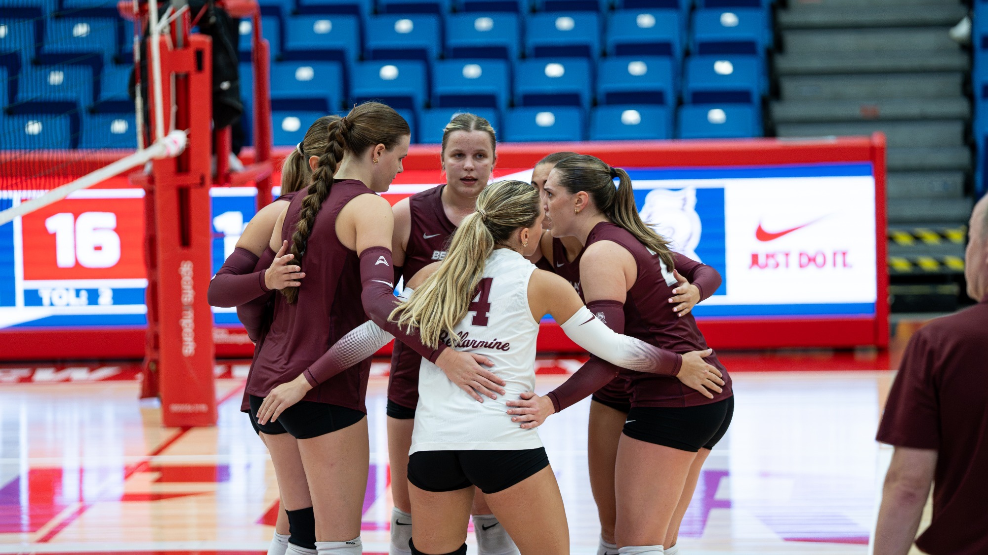 Volleyball players huddle during a match