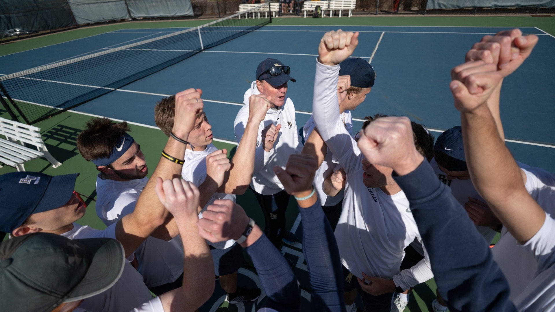 Men's tennis huddles up before a match.