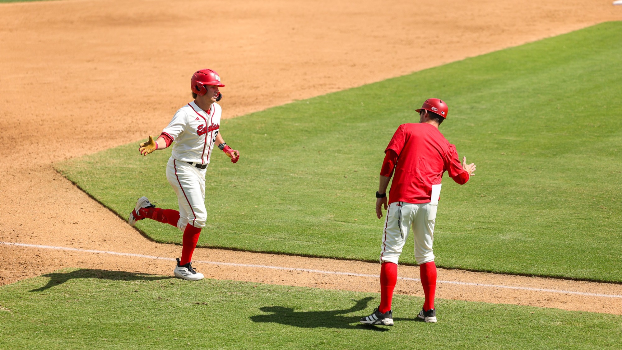 Jonny Tewinkle high-fiving Jesse Rodgers