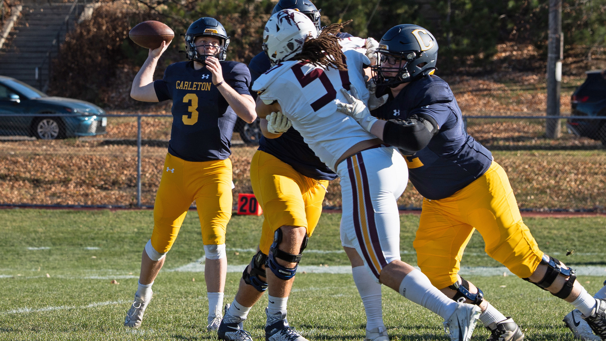 Jack Curtis throws a pass while offensive linemen block for him