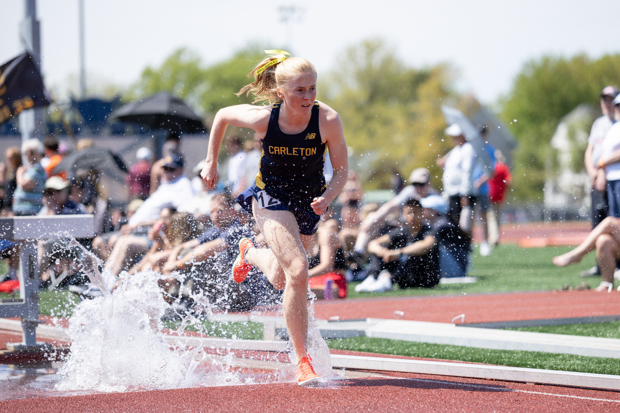 Sophie McManus splashing through water during the steeplechase