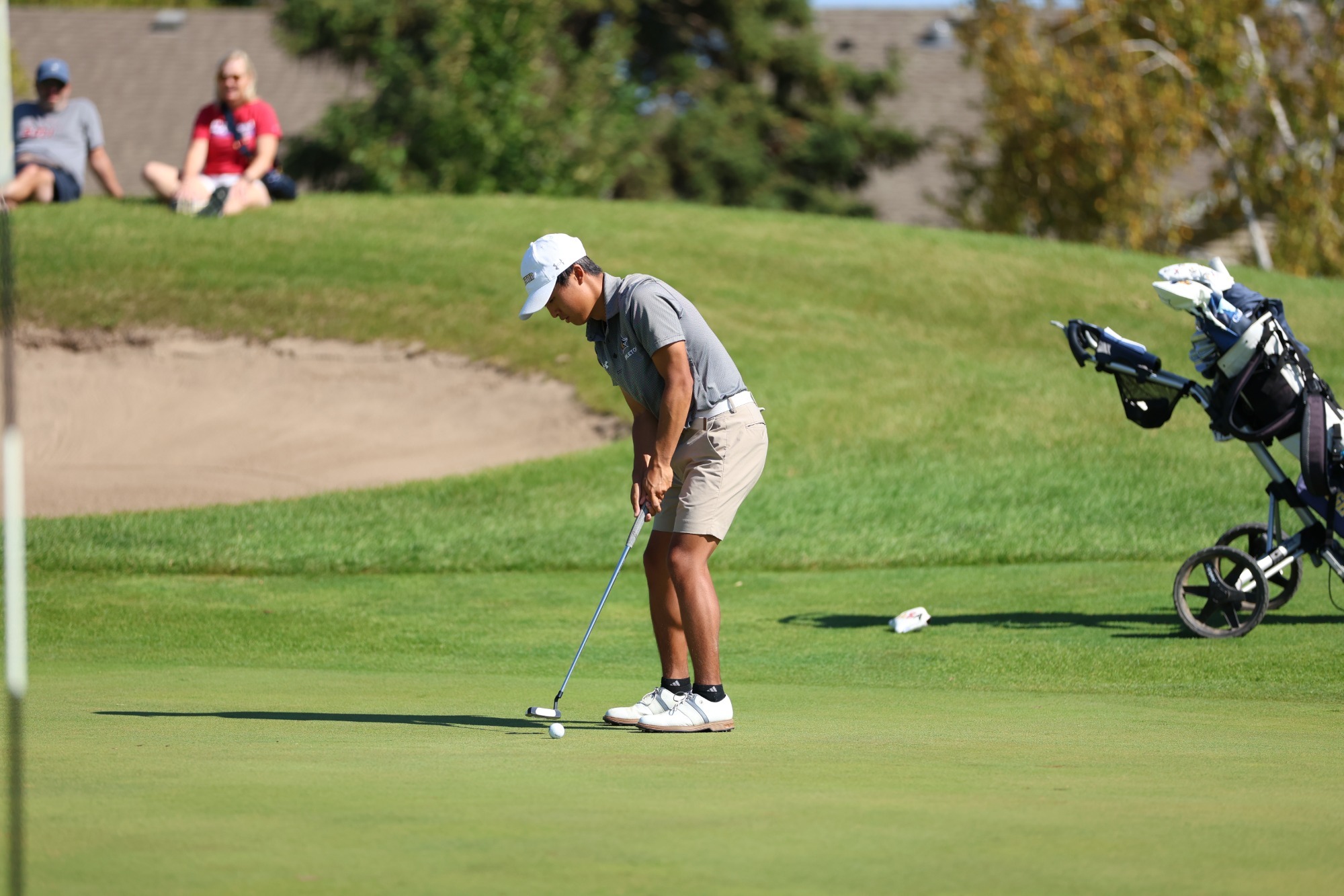 Sam Higaki puts on the green