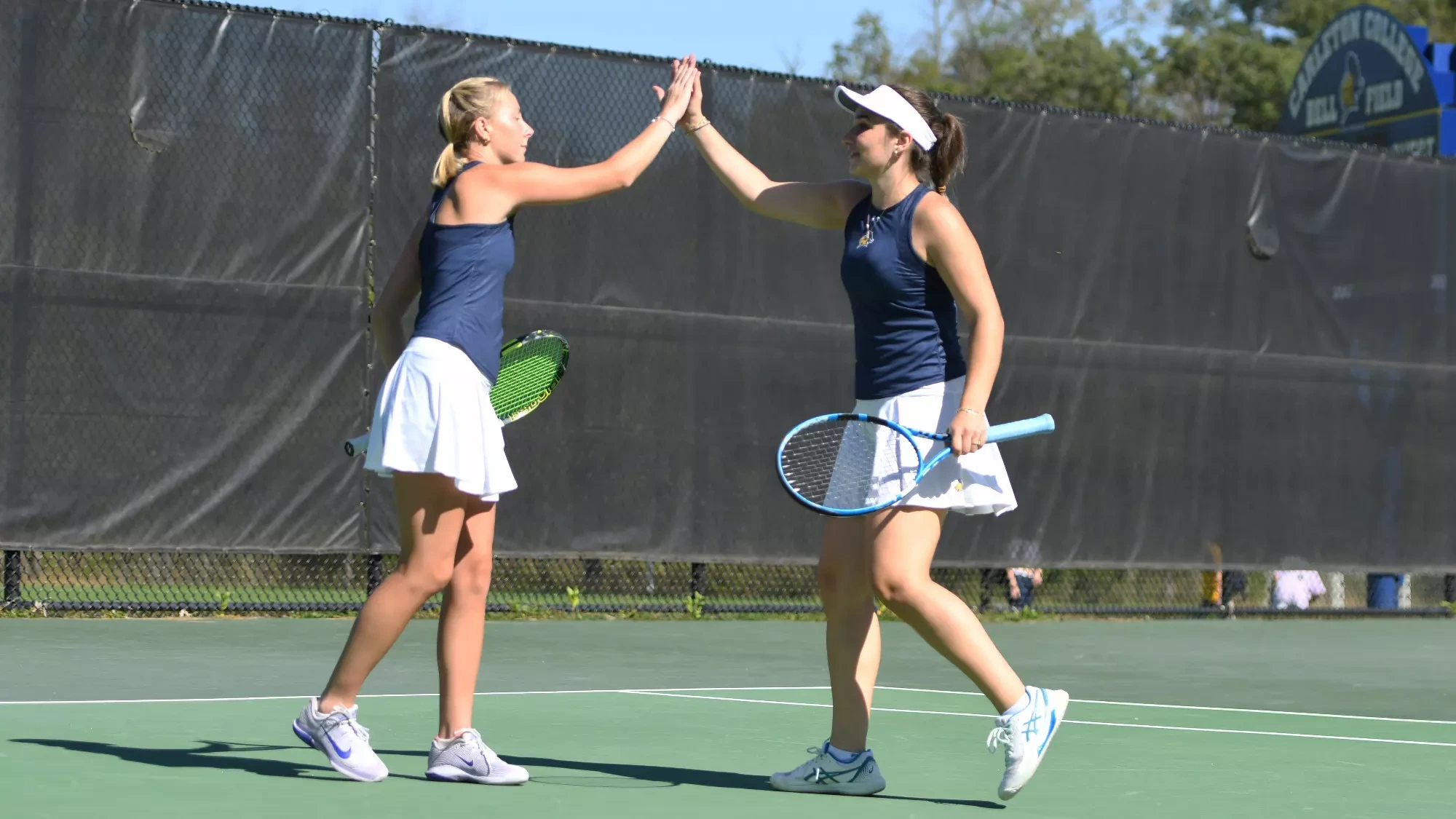 Kiley Pickens and Algara Dineva high five after winning a point