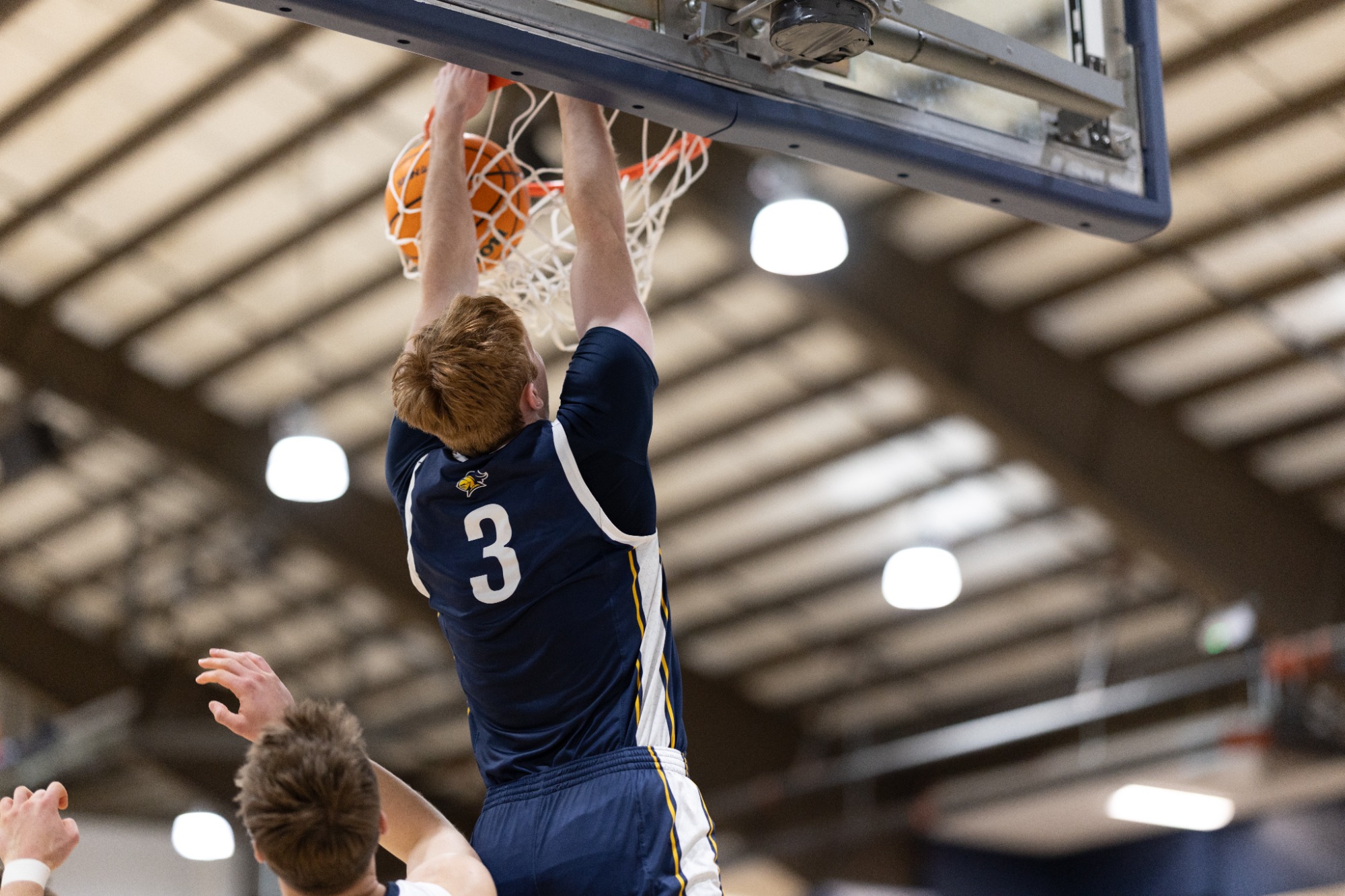 Sam Koelling hangs on the rim. 