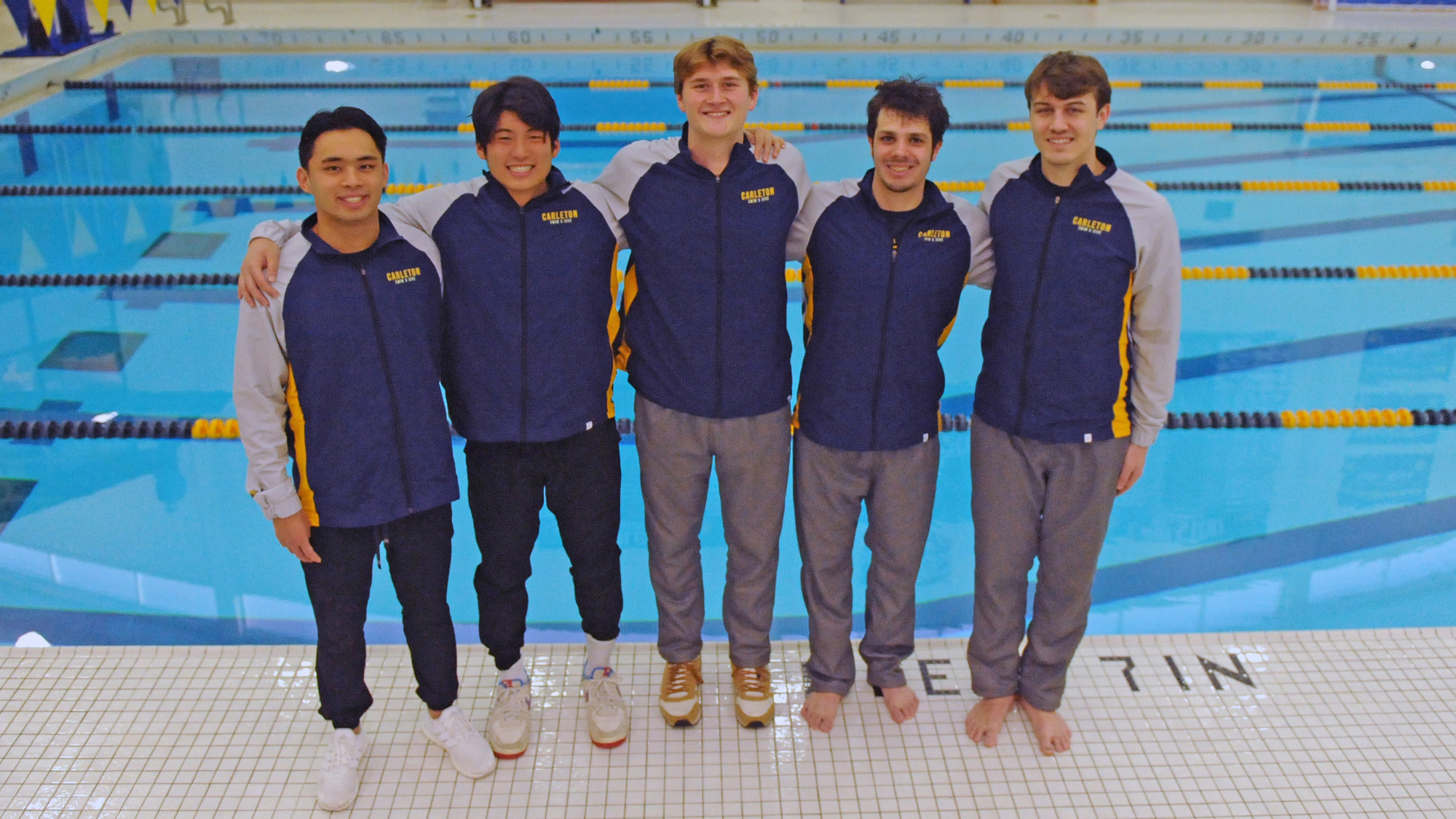 Nicholas Chang, Jeffrey Kong, Hans Anderson, Will Clausman, and Charlie Ruppe standing poolside