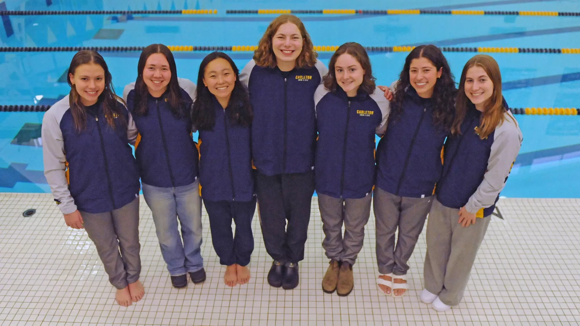 Stephanie Baranov, Lily Wong, Zoe Morton, Eleanor Hebard, Aviva Sachs, Lola Taraday, and Alison Trackman standing poolside