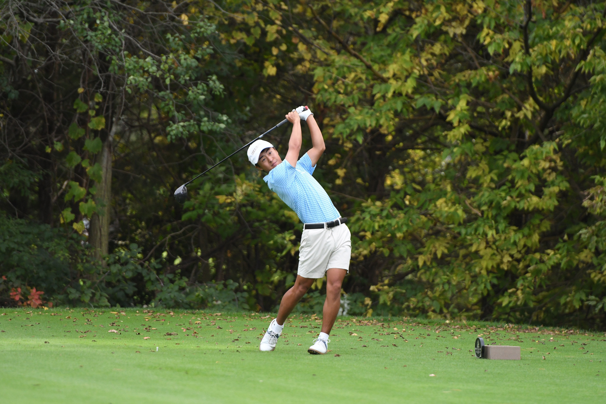 Sam Higaki hits a tee shot