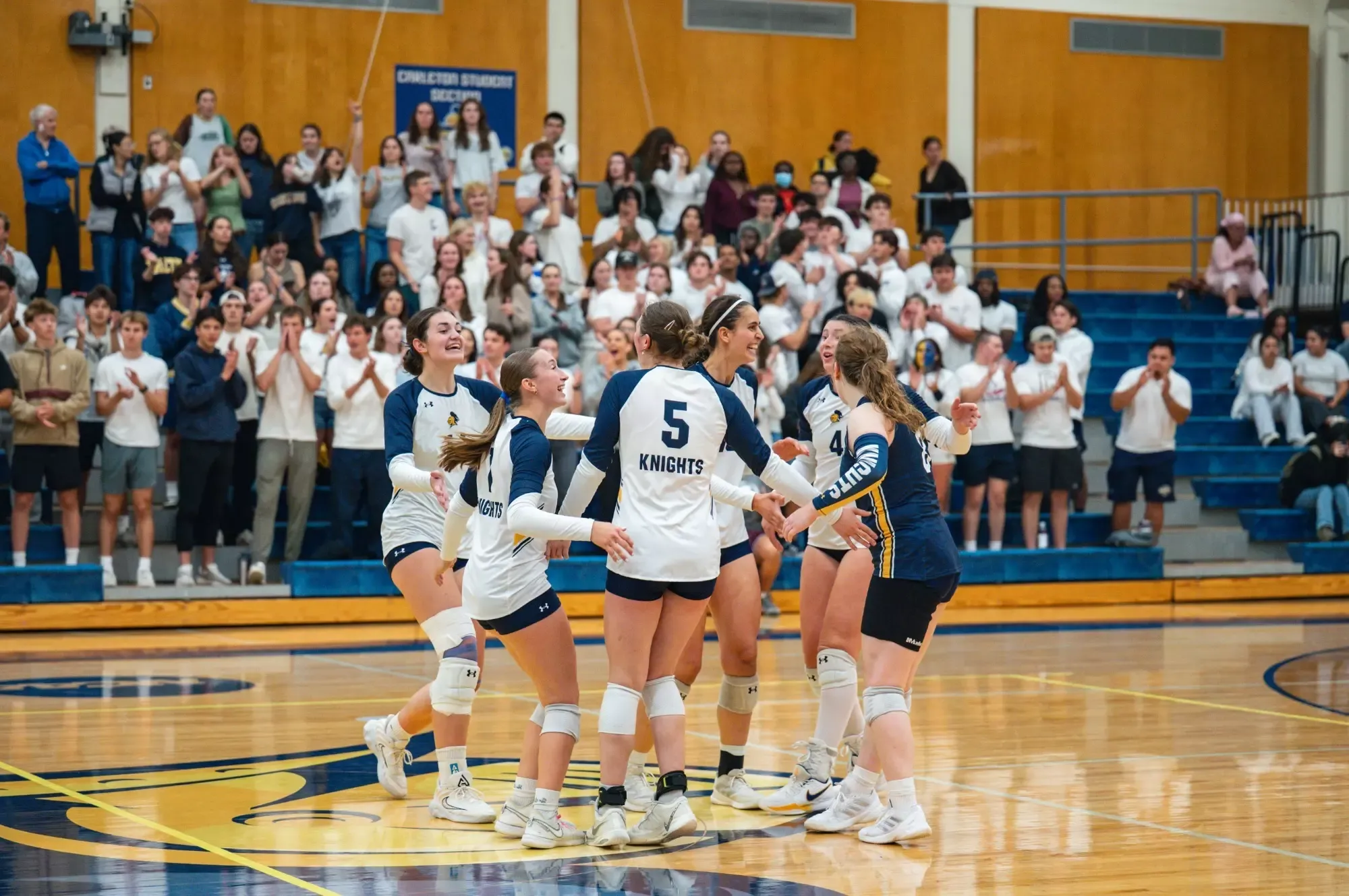 The team gathers to celebrate a point