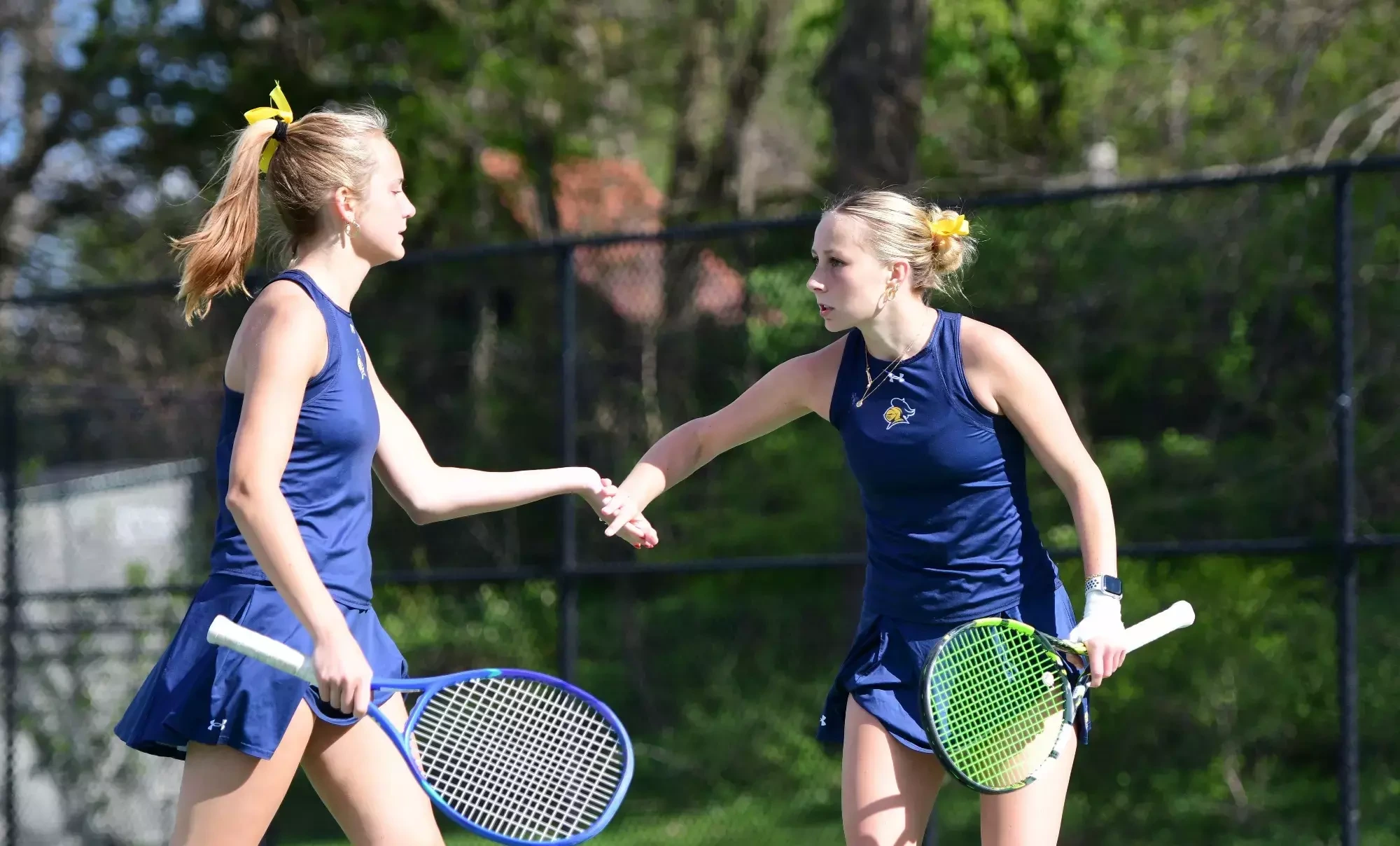 Gabriela Cilella and Kiley Pickens celebrate winning a point.