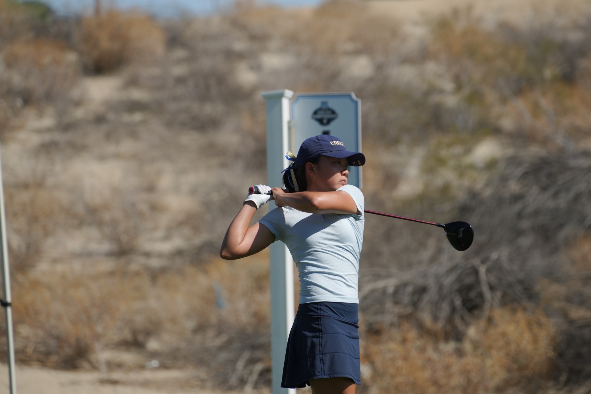 Anna Lee looks down the course after swinging.