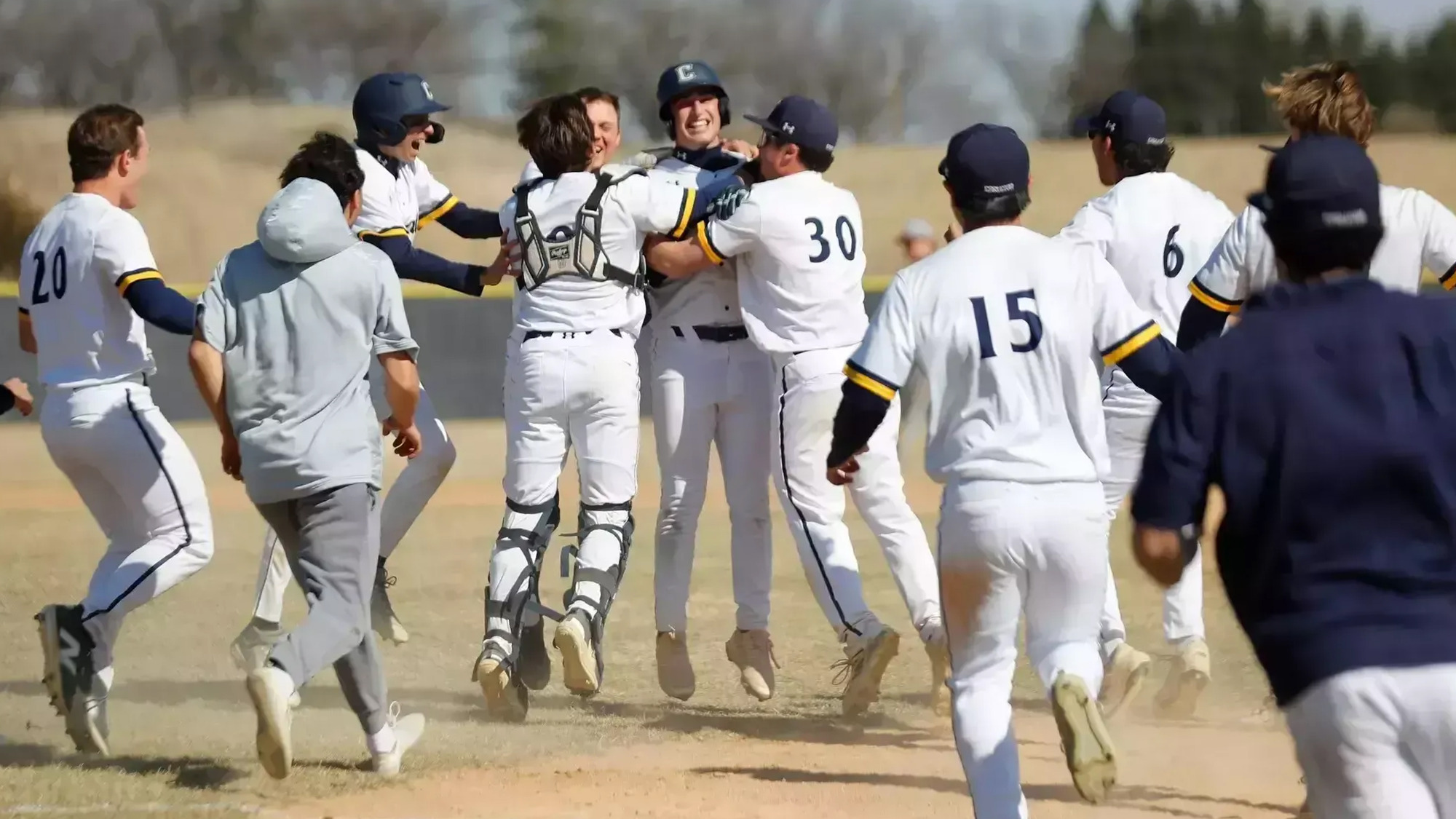 Baseball team celebrates after a walk off hit.